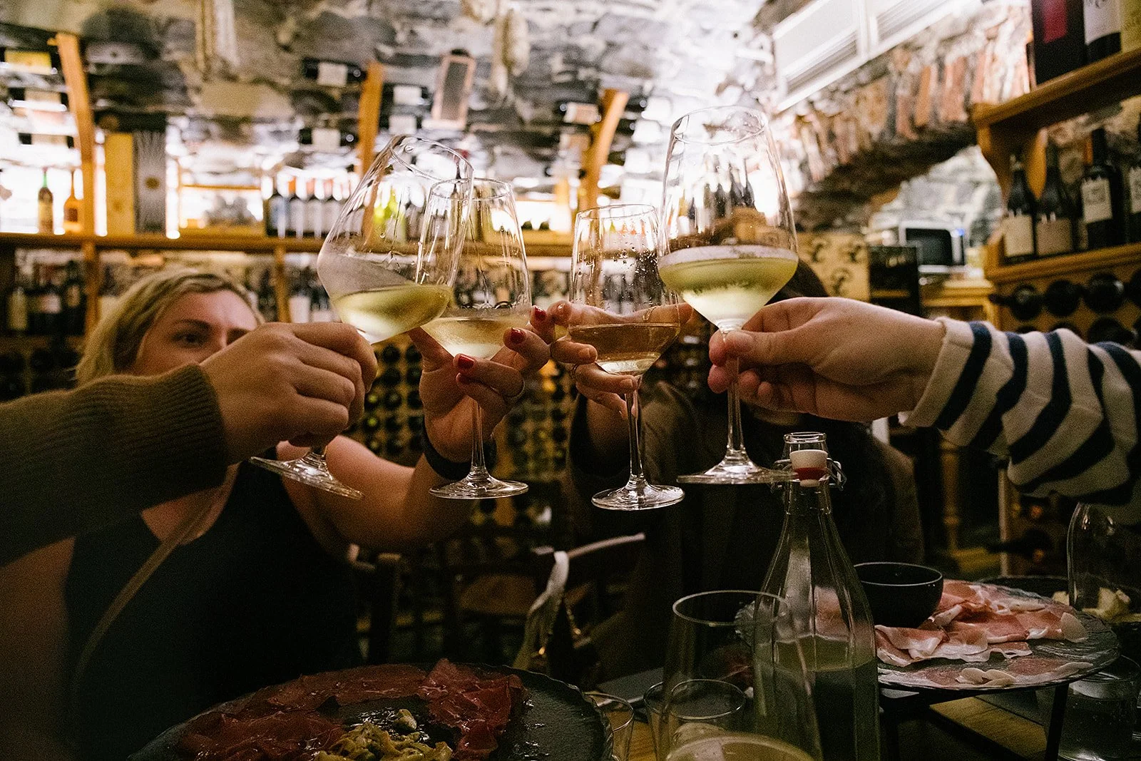 Women toasting wine glasses