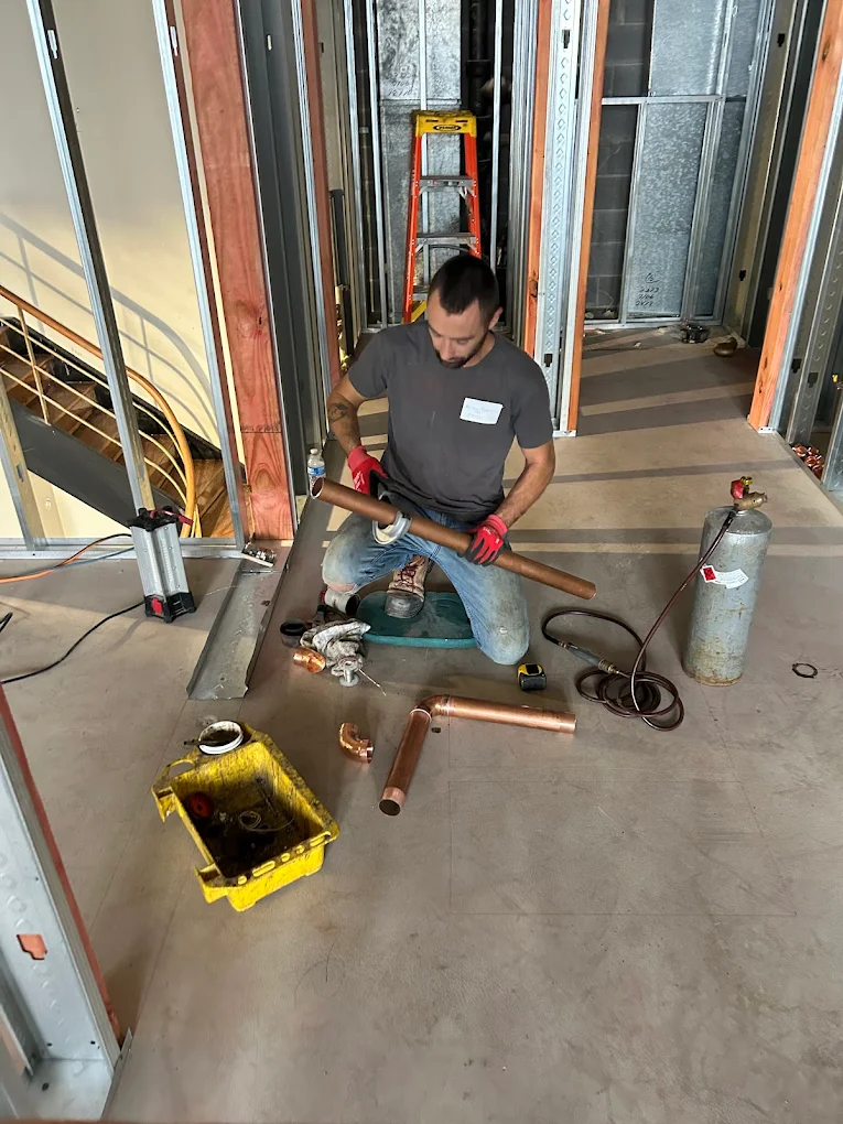 LQC Plumbing technician working on copper pipe installation