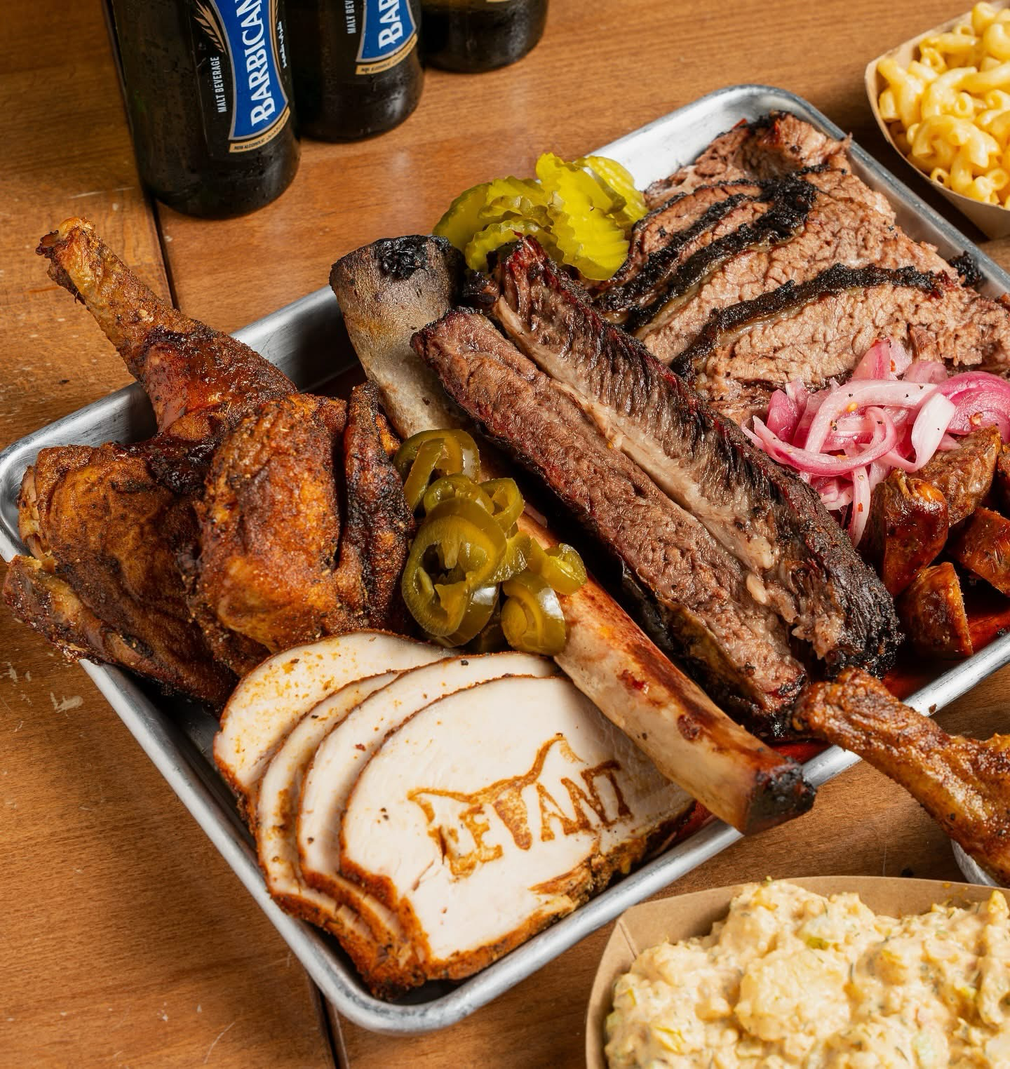 The Levant Feast — brisket, sausage, chicken, and turkey on a wooden board