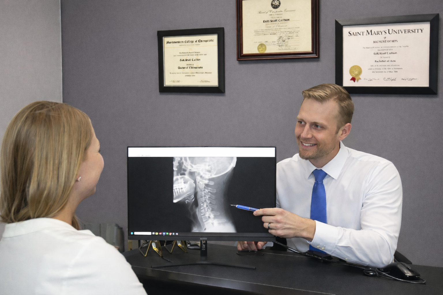 Dr. Erik Carlson reviewing x-rays with a patient