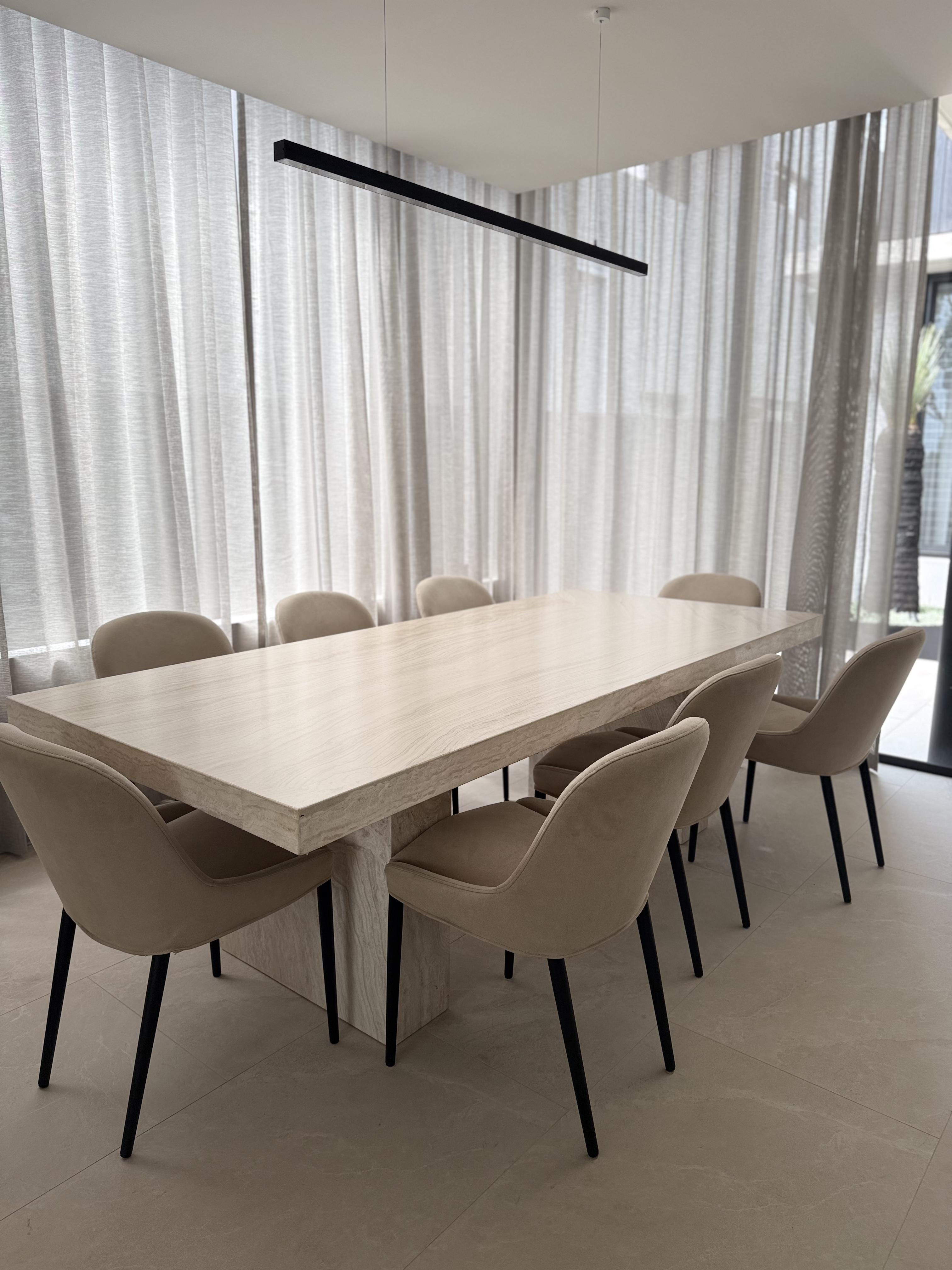 Large marble dining table with beige chairs, table surface protected by Pro Surface Protection film