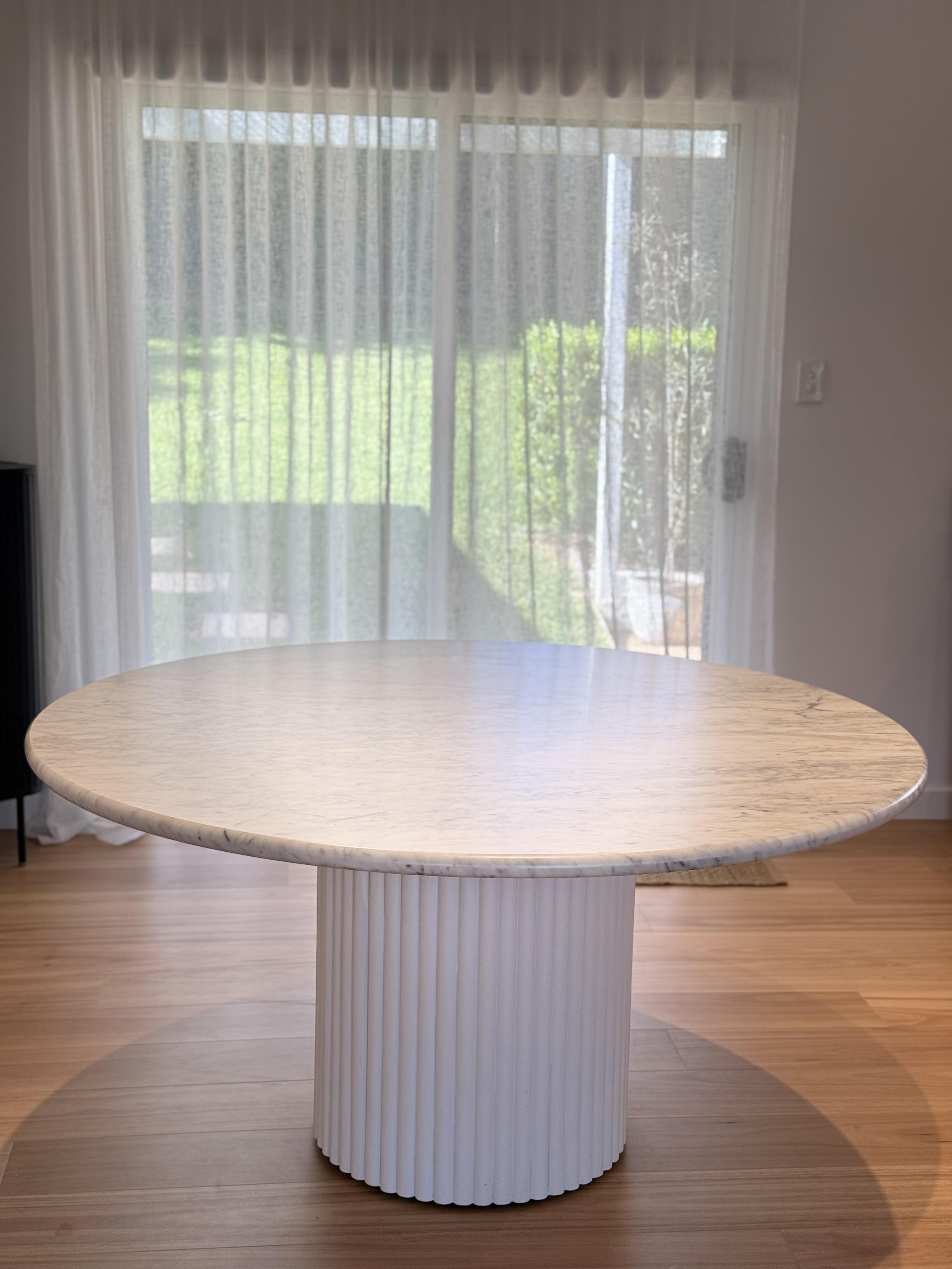 Round marble dining table with fluted pedestal base, table surface protection film by Pro Surface Protection