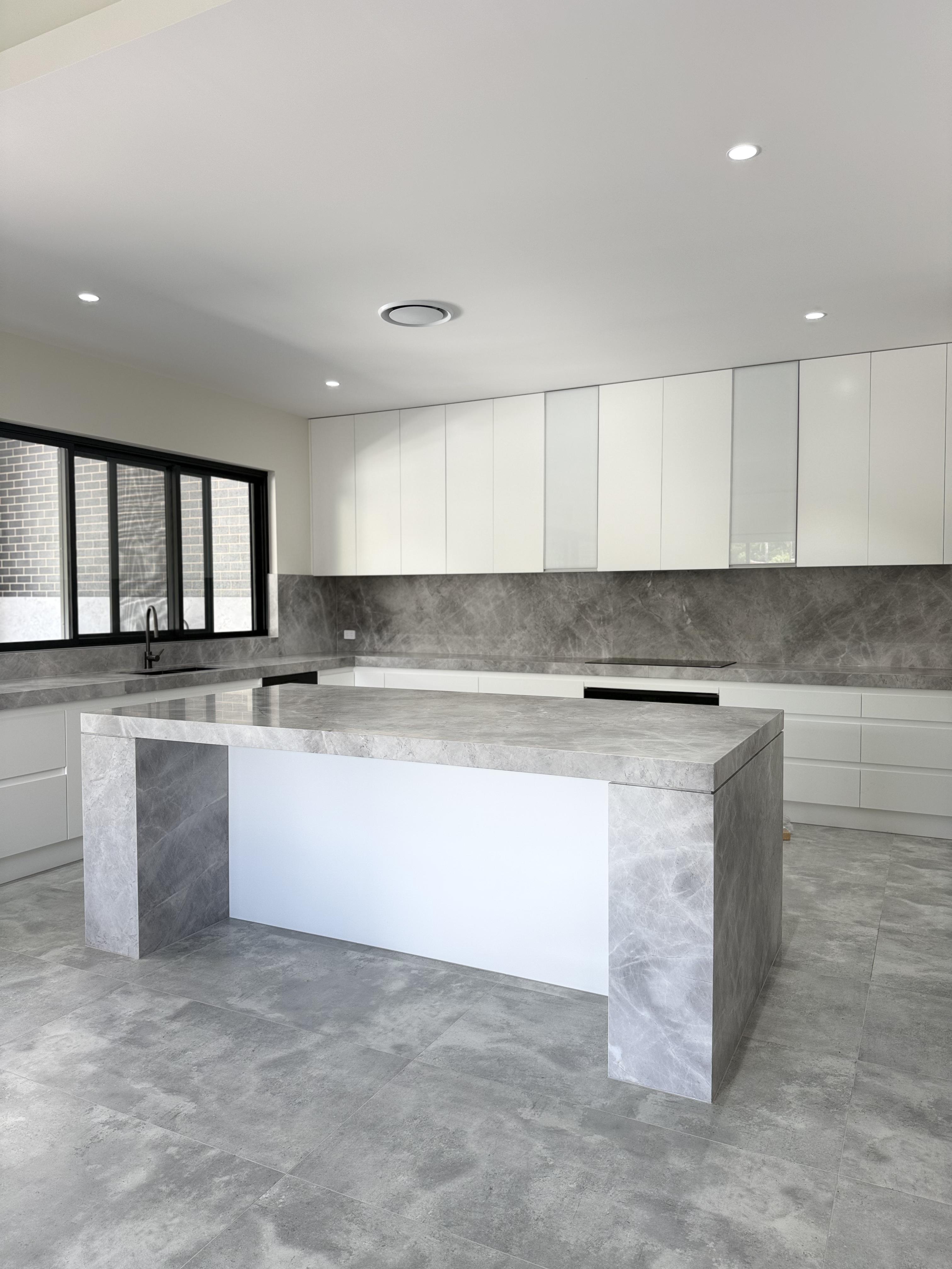 Minimalist grey stone kitchen island with crystal-clear surface protection film by Pro Surface Protection Sydney