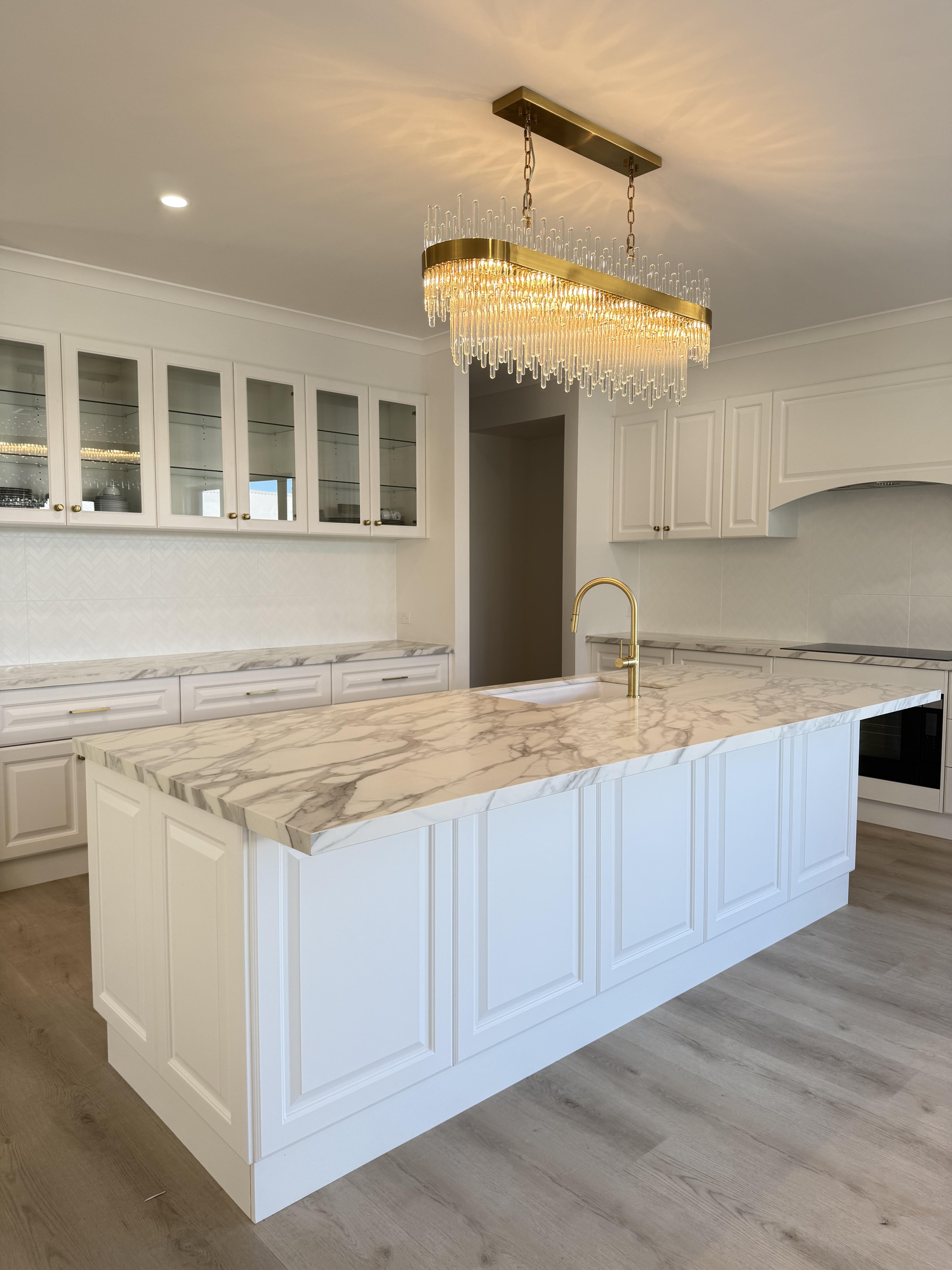 Luxurious white kitchen with marble island and gold chandelier, Pro Surface Protection marble film