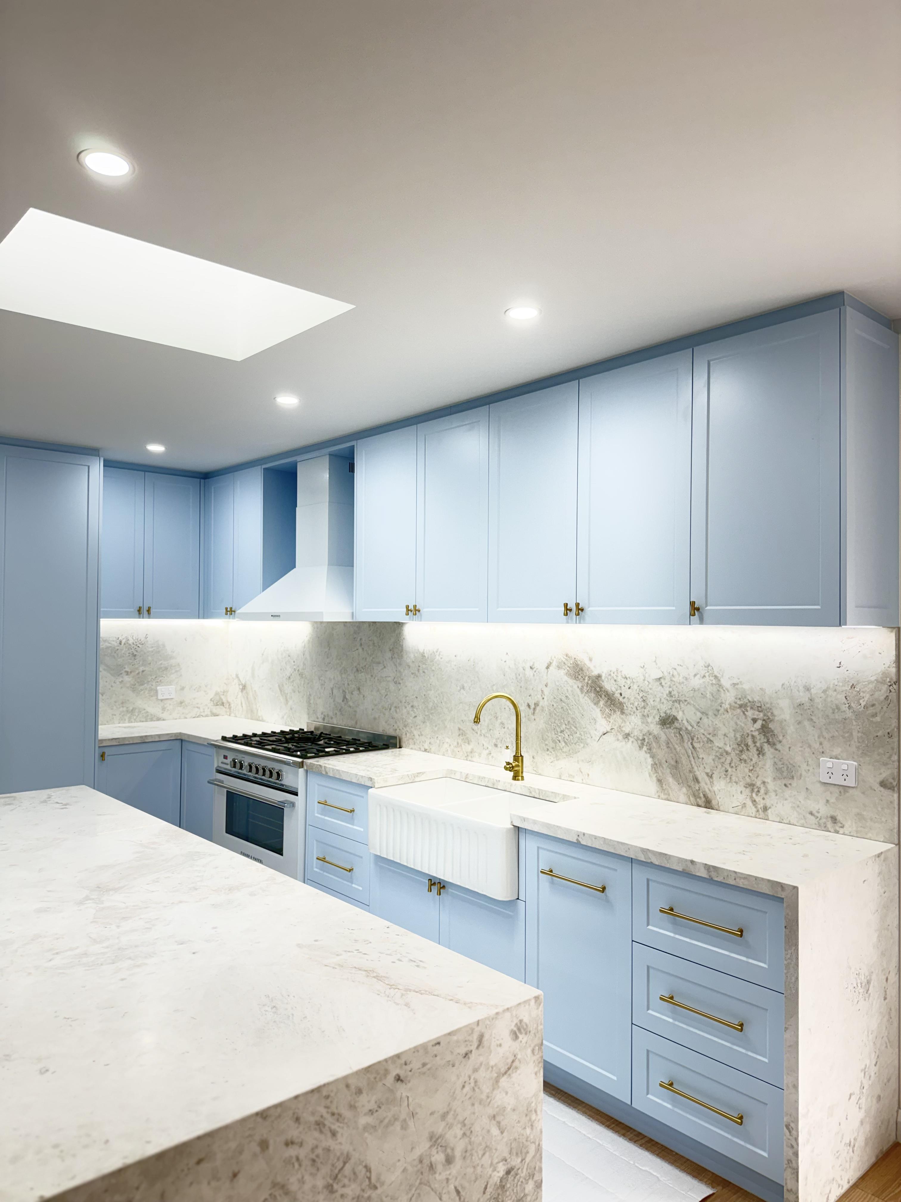 Blue kitchen cabinetry with white marble benchtop and surface protection film by Pro Surface Protection Melbourne
