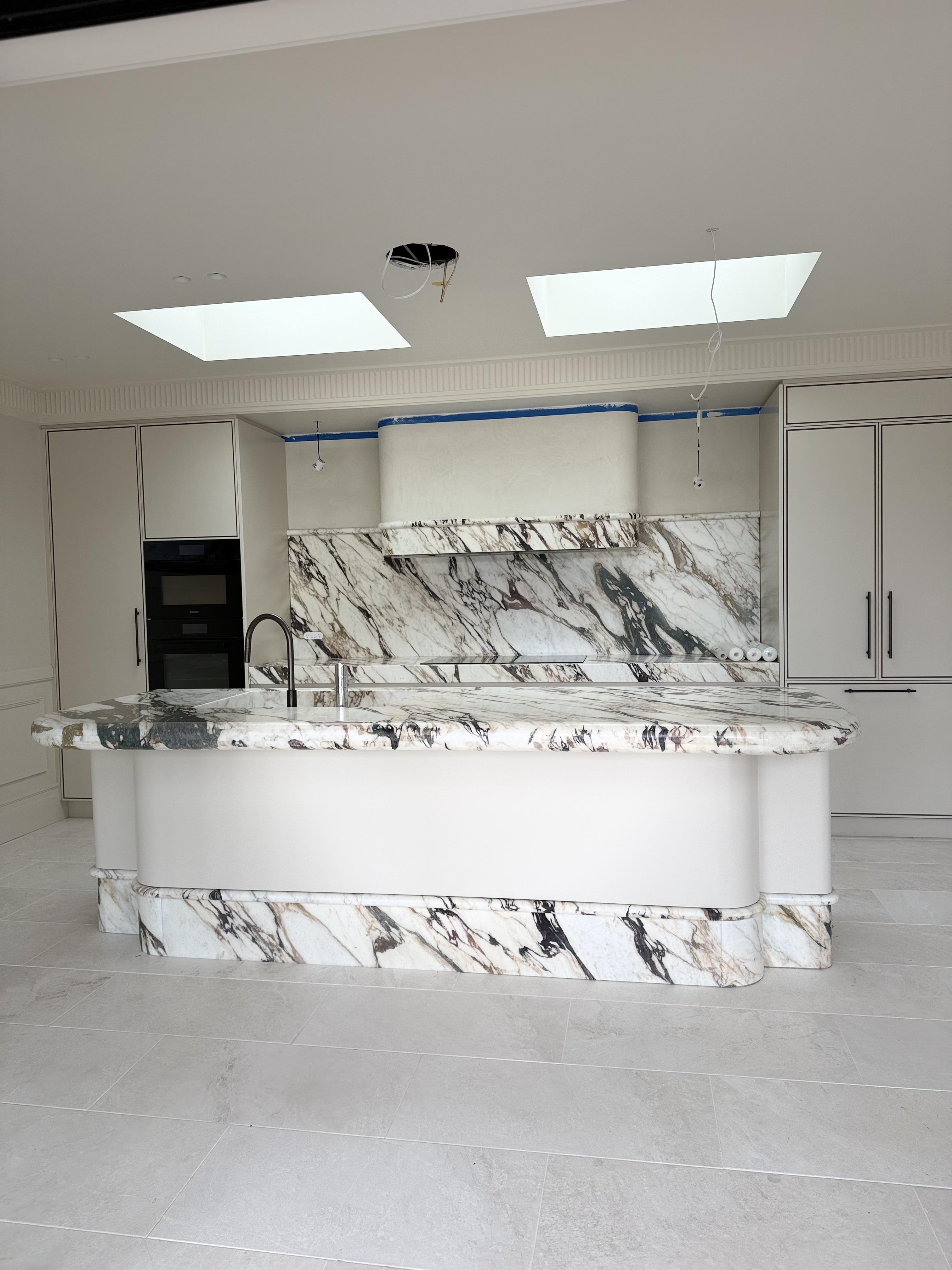 Curved marble kitchen island with dramatic stone veining, protected by Pro Surface Protection film in Sydney