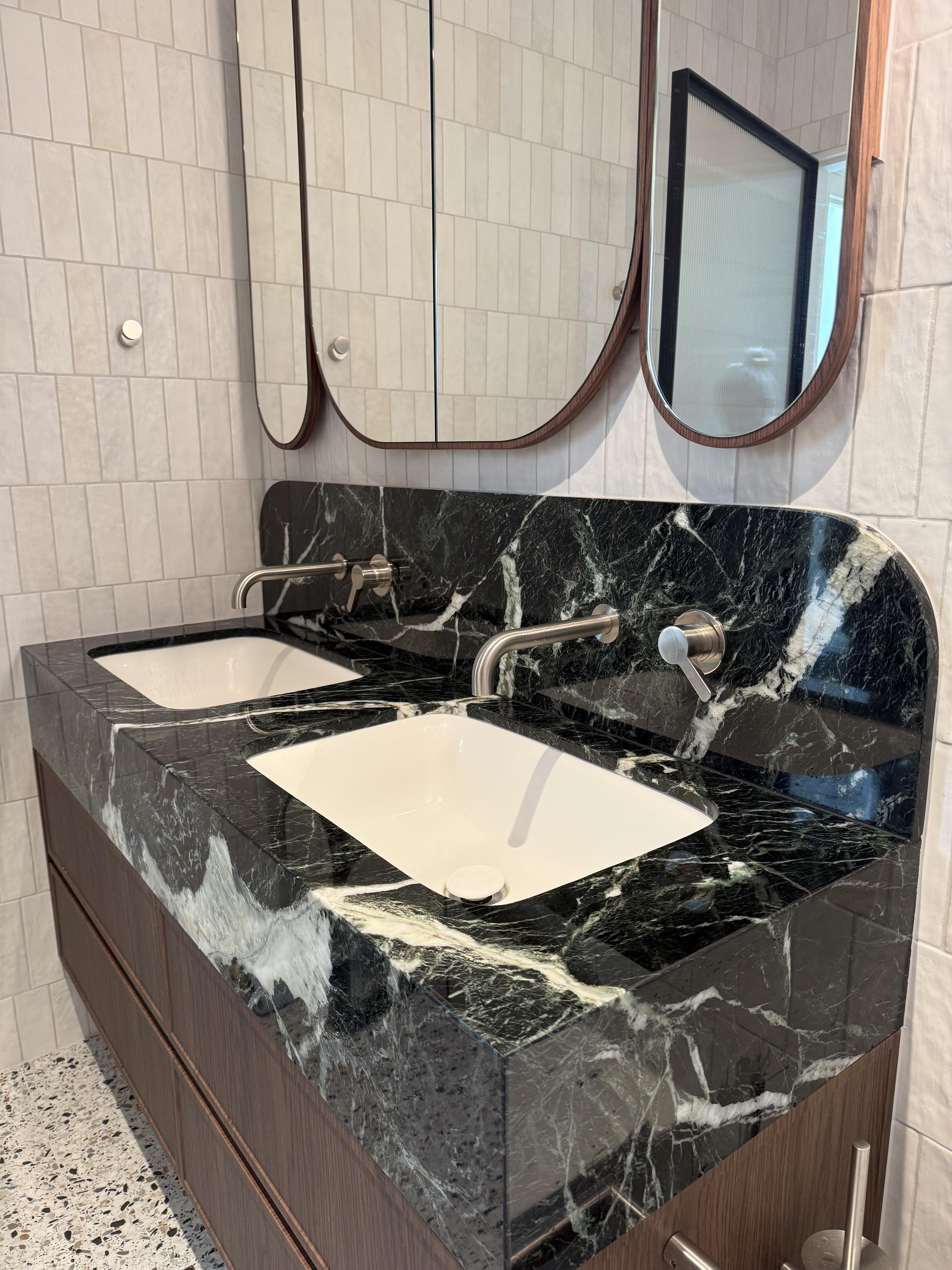 Bathroom vanity with dark green marble benchtop and twin sinks, marble protection film by Pro Surface Protection