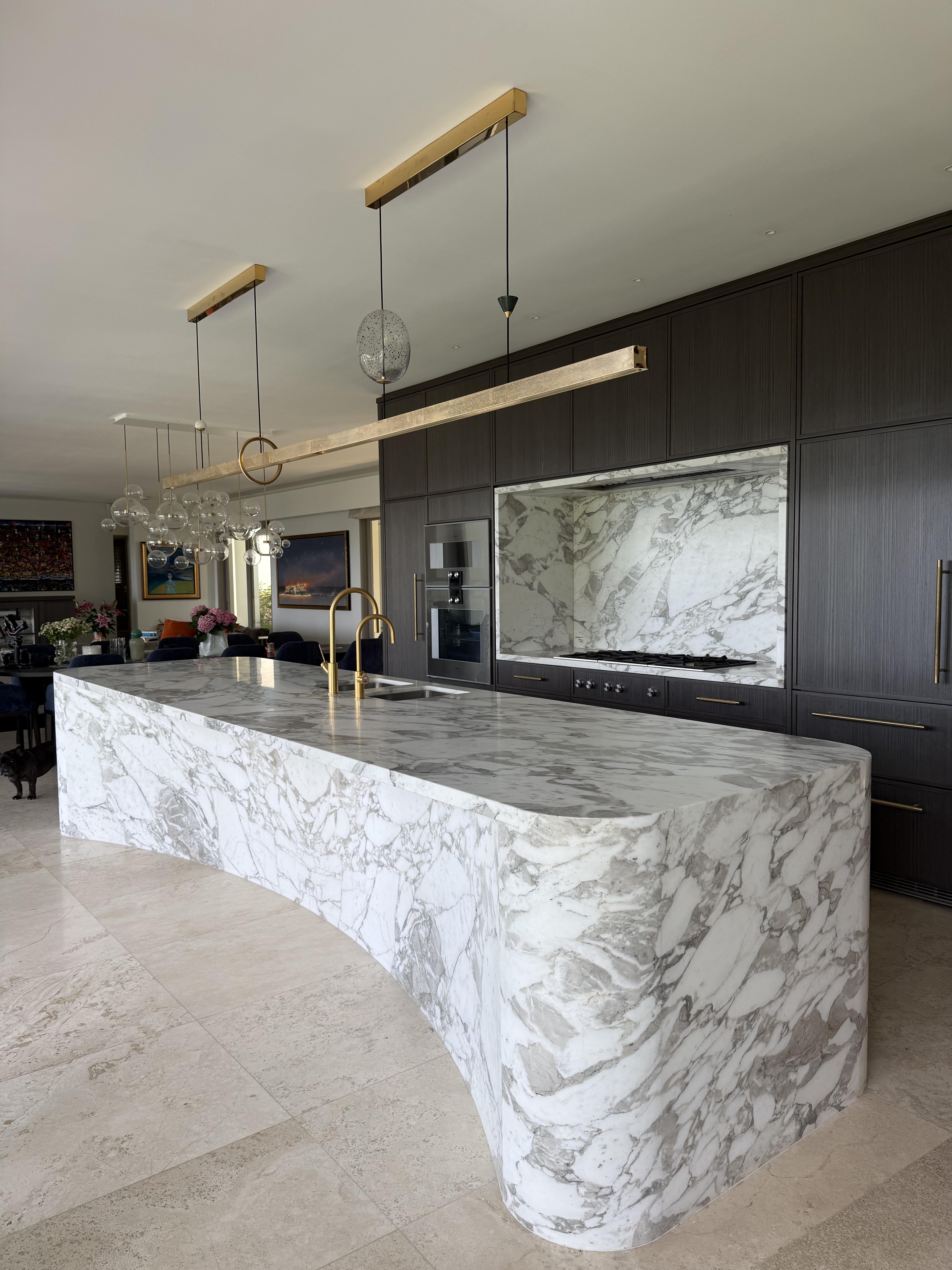 Dramatic curved marble kitchen island in modern Sydney home, protected by Pro Surface Protection film