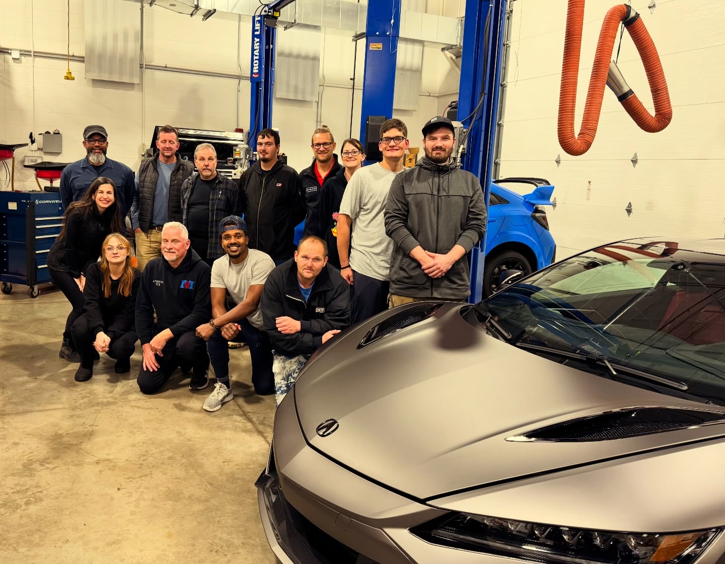 Automotive technician mentoring a student
