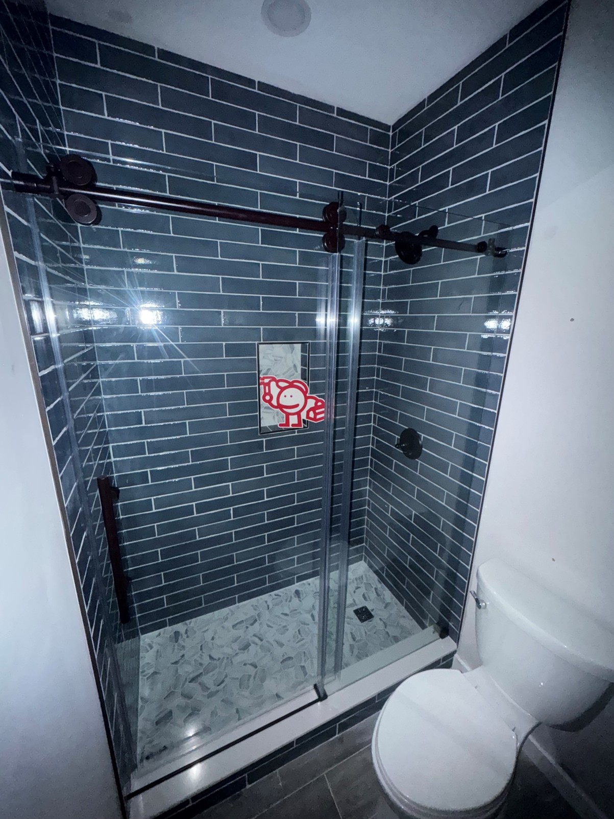 dark subway tile shower with glass enclosure Canton Georgia — Marshall's Handyman Service