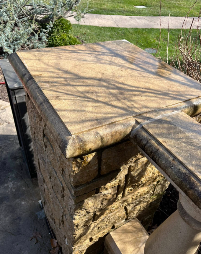 Dirty stone column before pressure washing