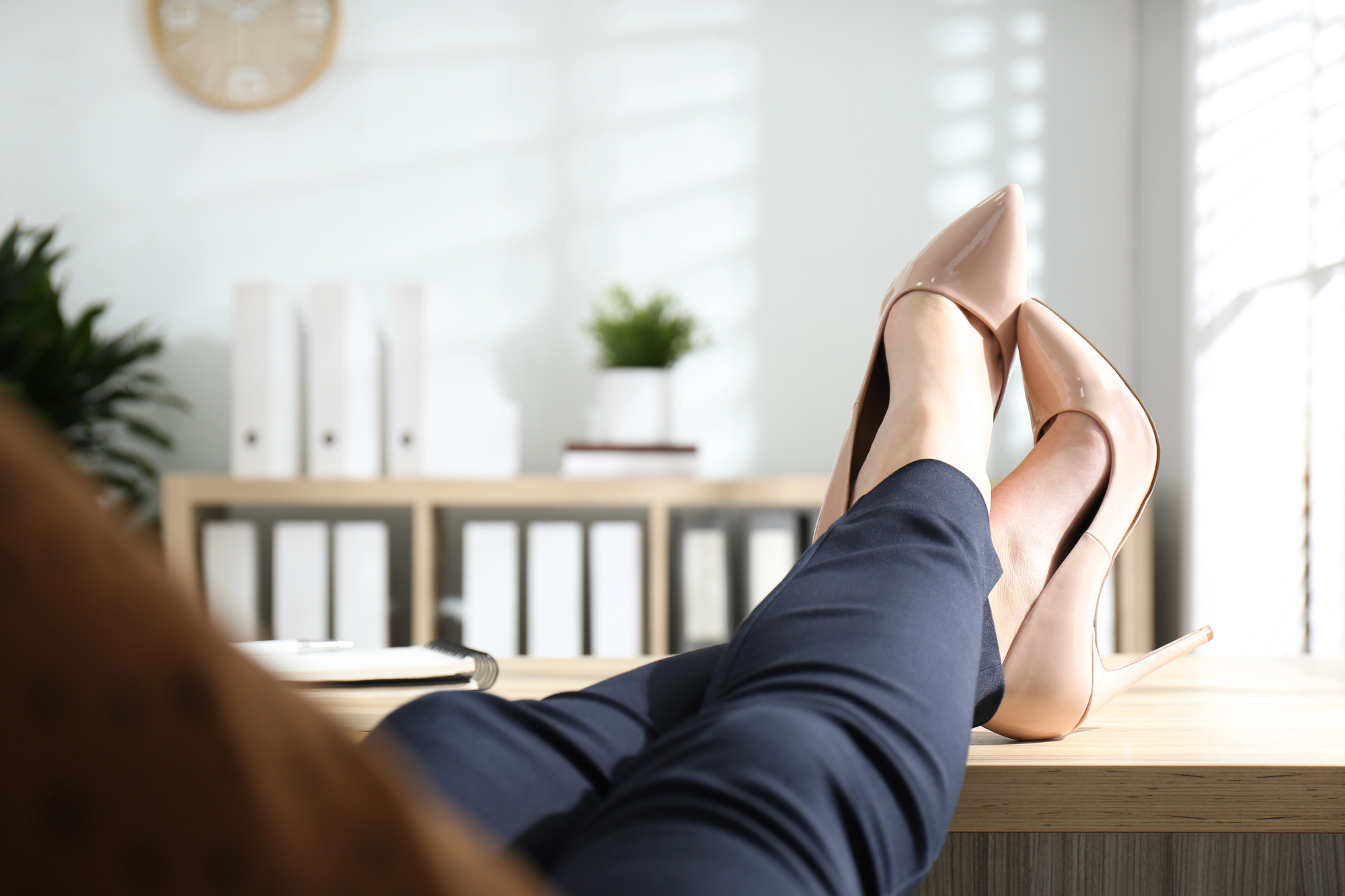 Entrepreneur relaxed at desk with feet up