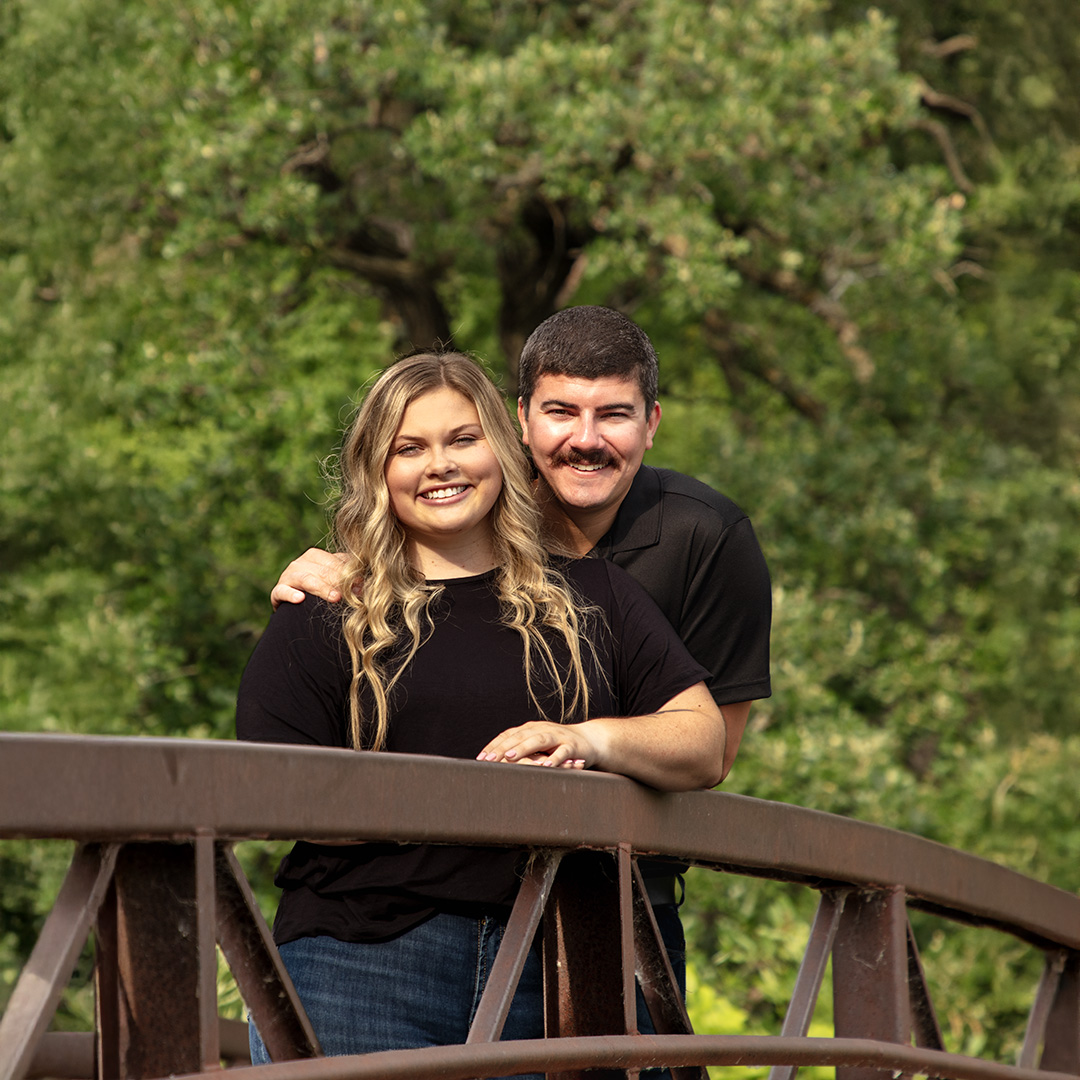 Couple standing on a bridge