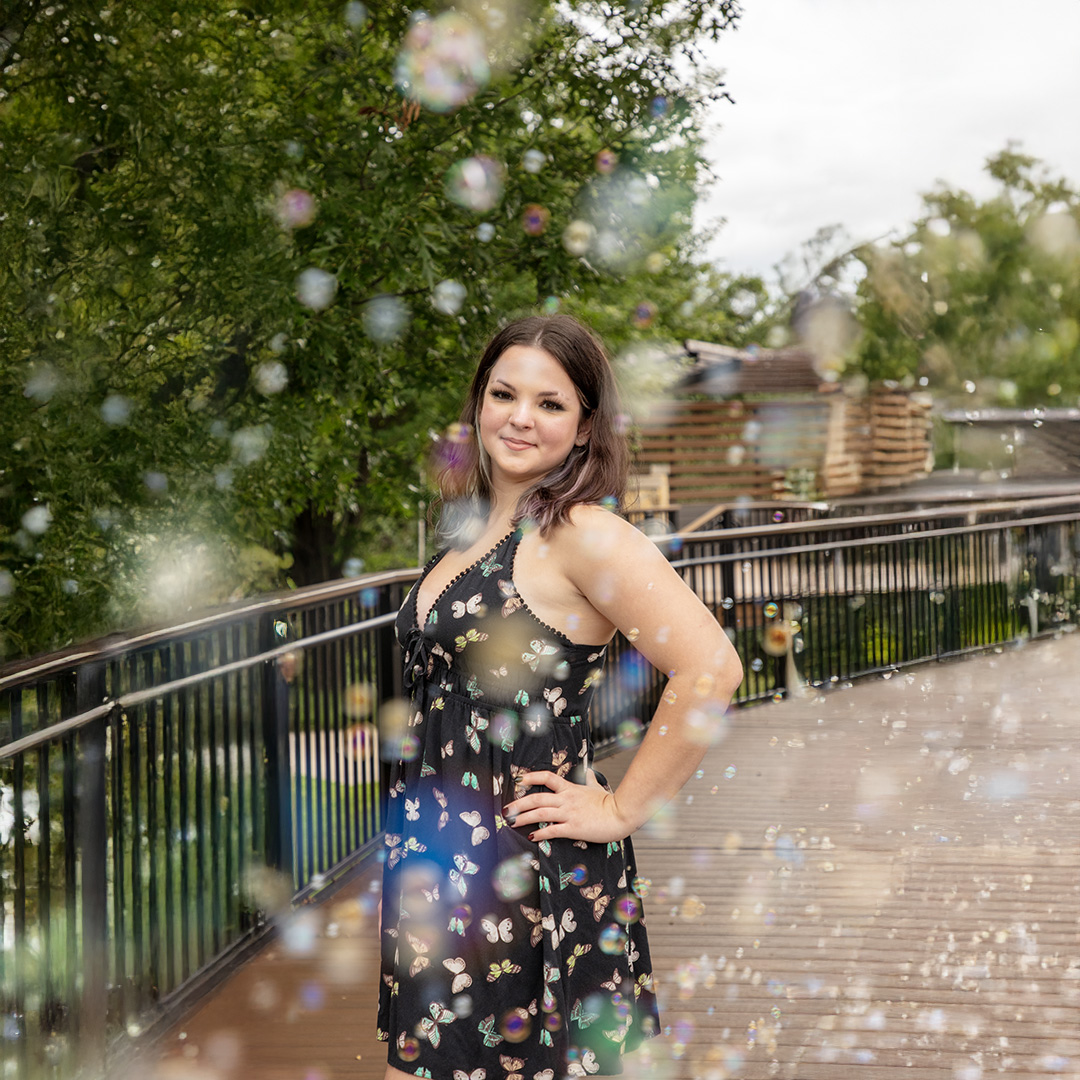 Senior girl on a bridge with bubbles