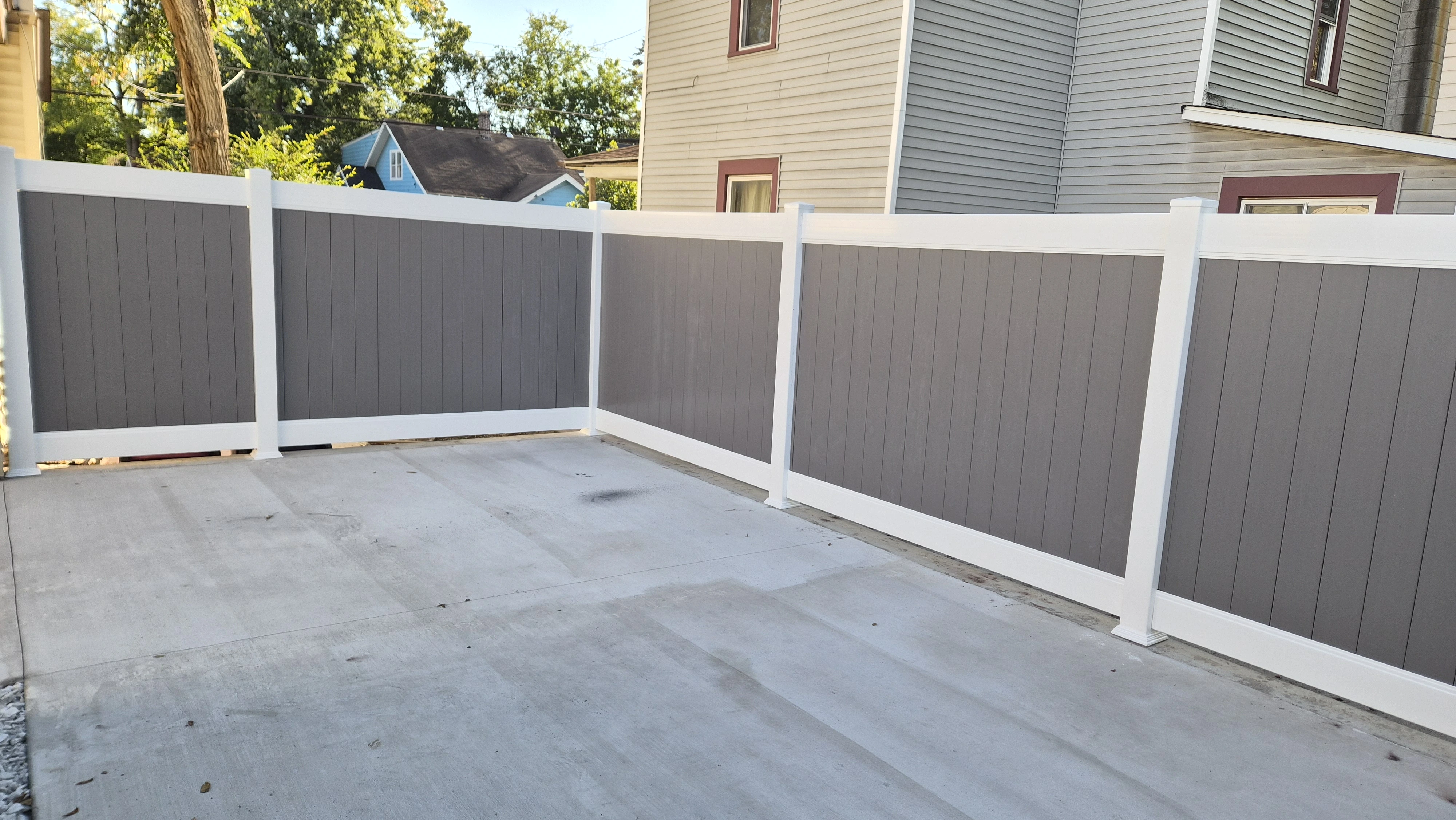 Grey and white vinyl privacy fence