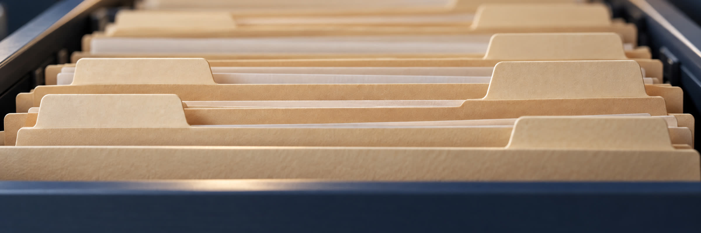 Well-organized color-coded legal case files and client document folders in archive drawer