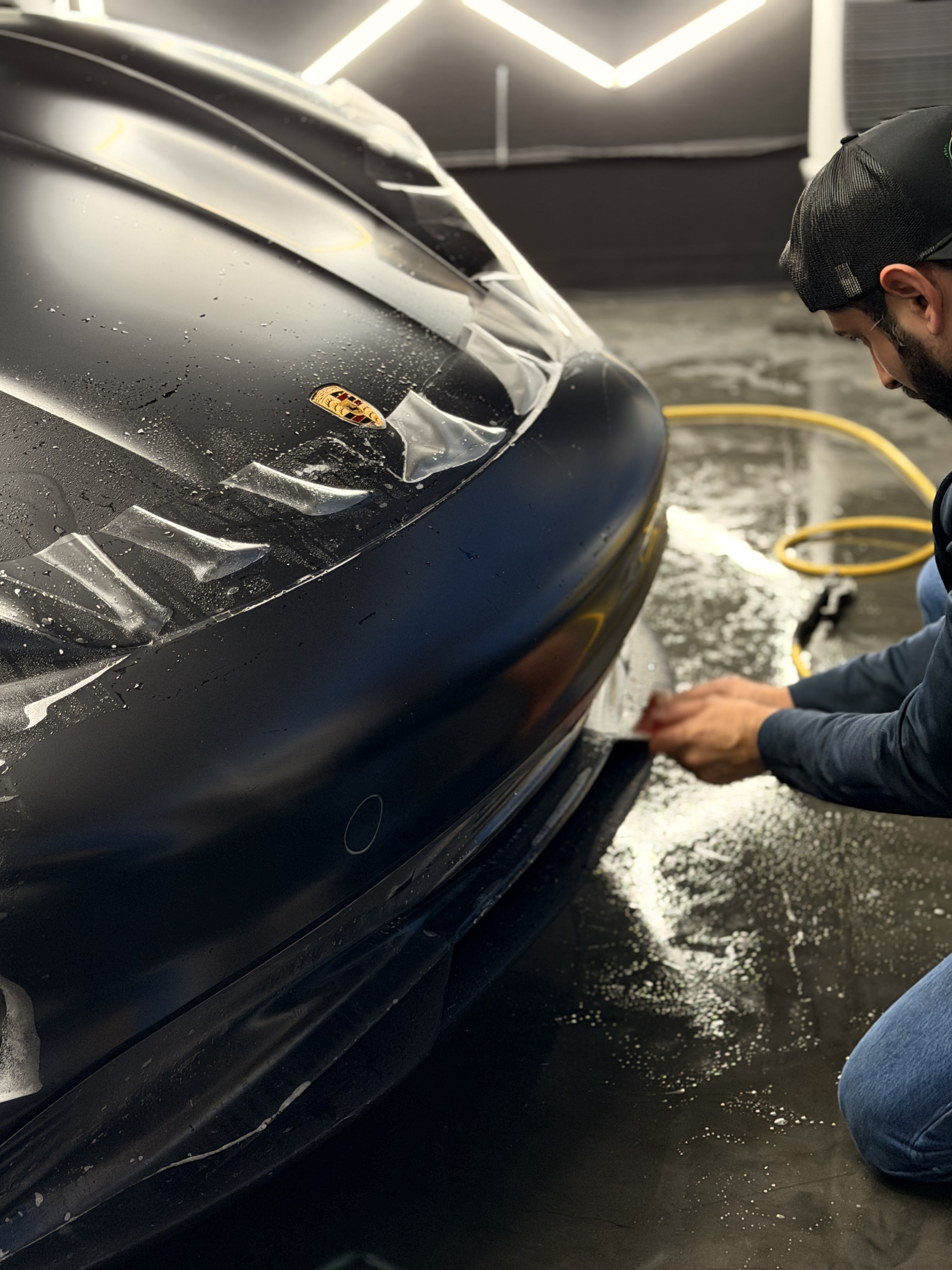 CDA Auto Styling technician working on a luxury vehicle