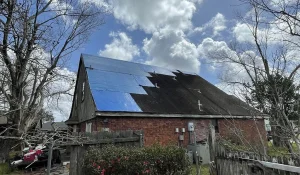 Emergency roof tarping on a home in Louisiana