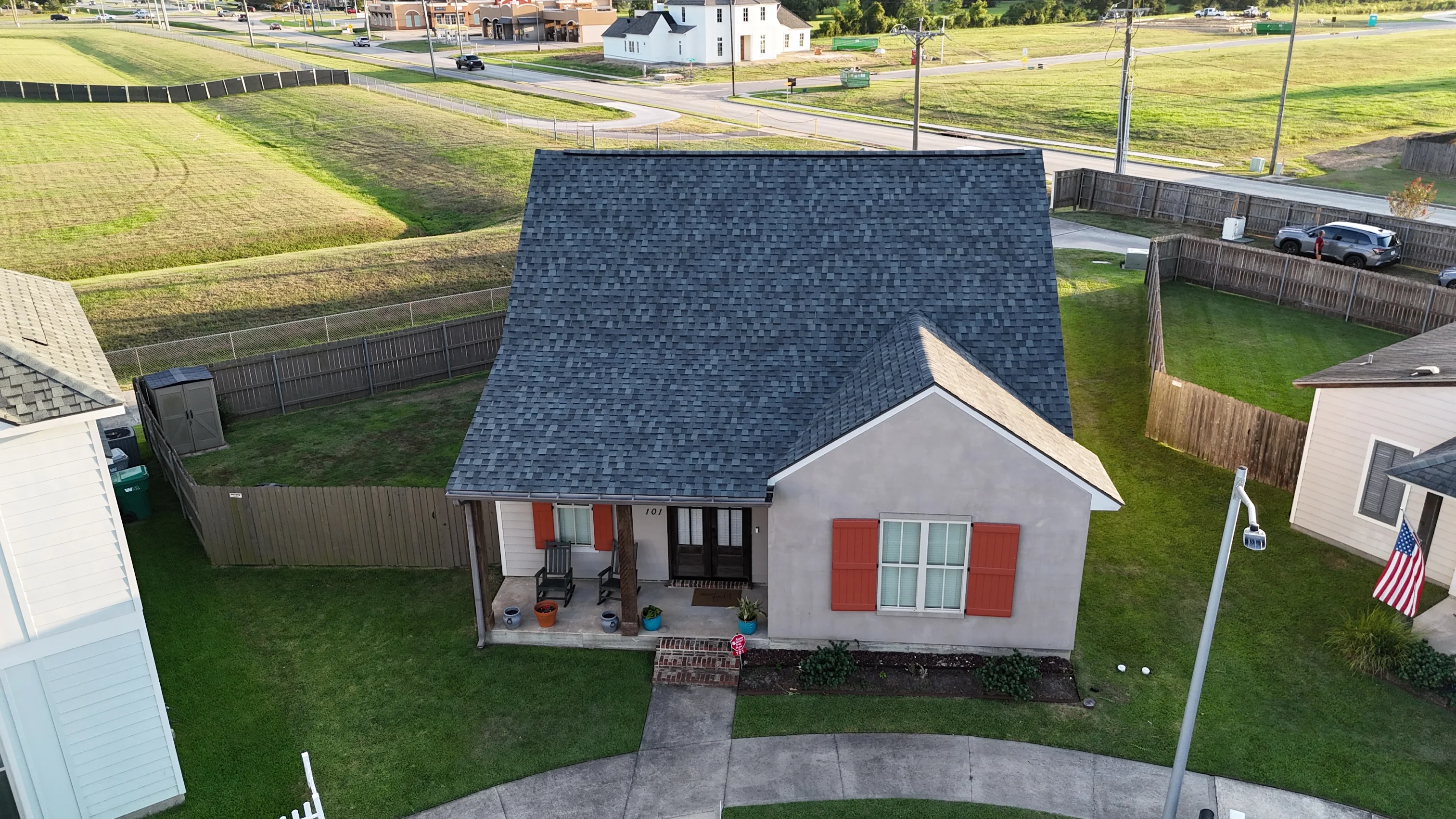 Aerial view of completed residential shingle roof replacement in Acadiana neighborhood