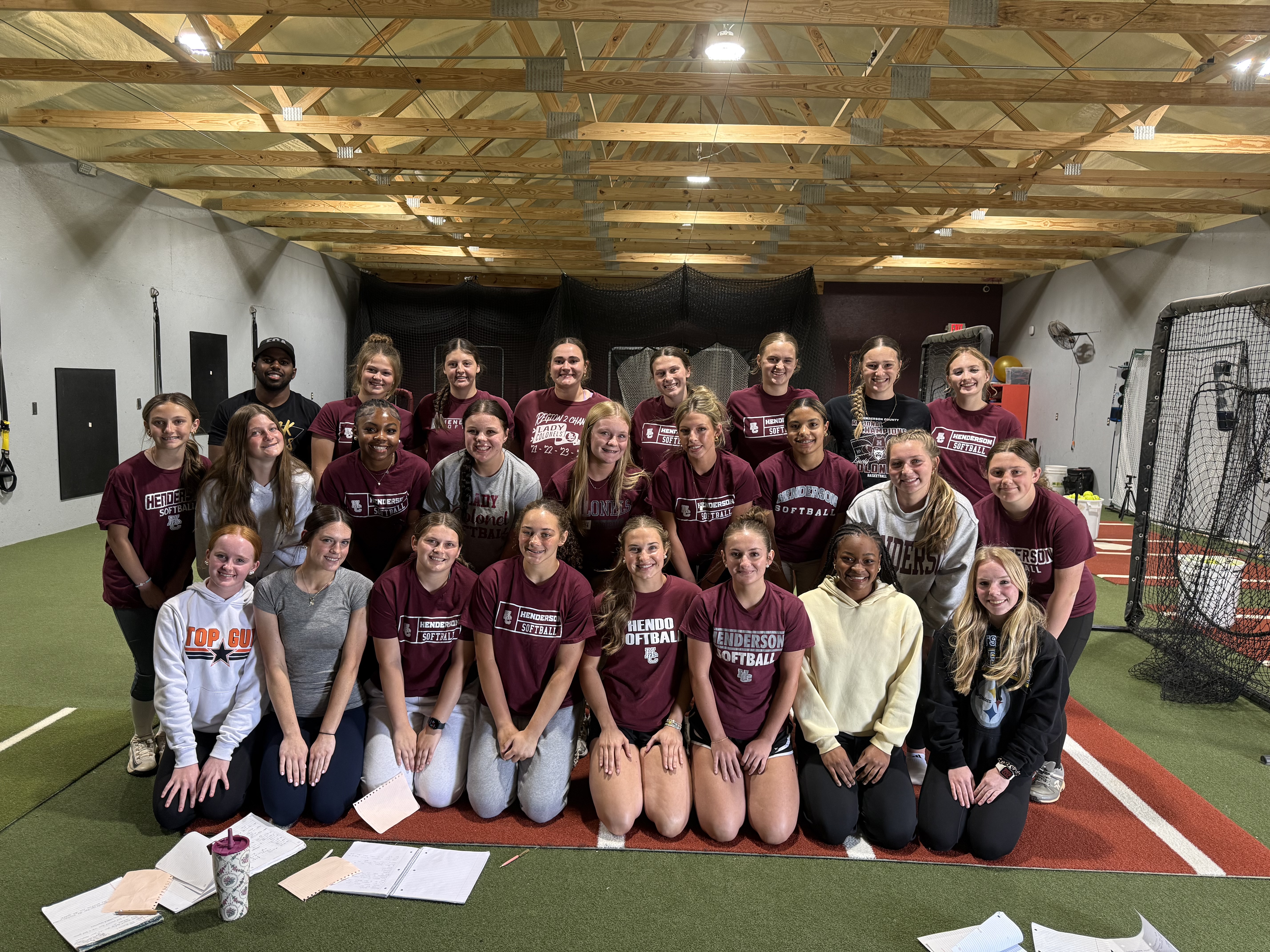 Coach Dee with softball athletes following a team mindset session
