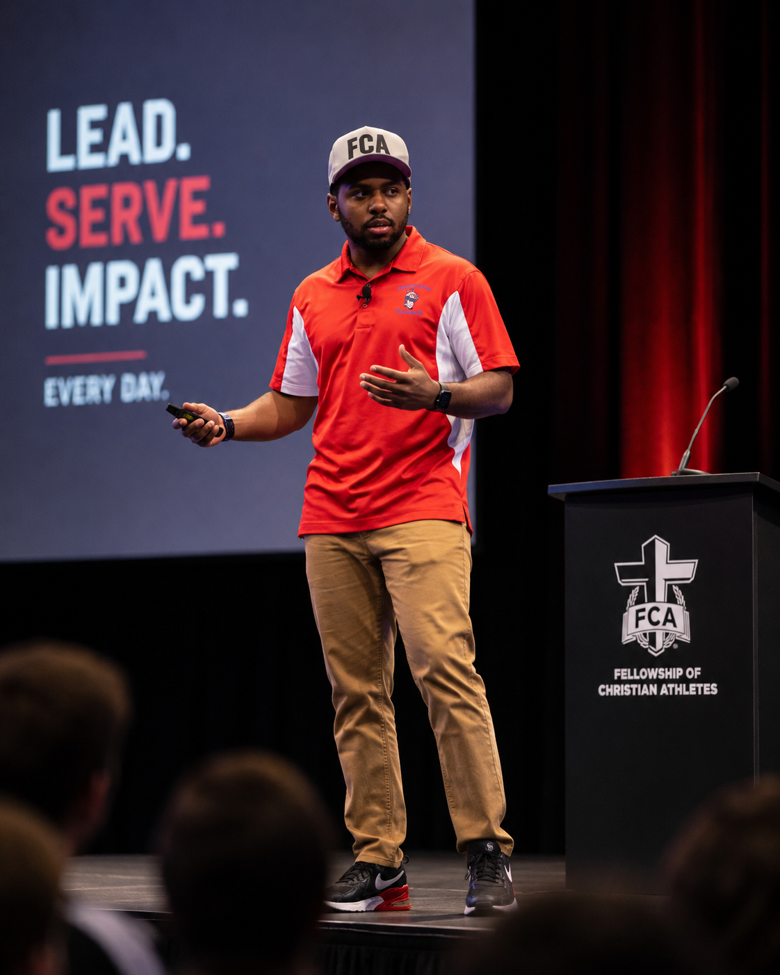 Coach Dee speaking on stage
