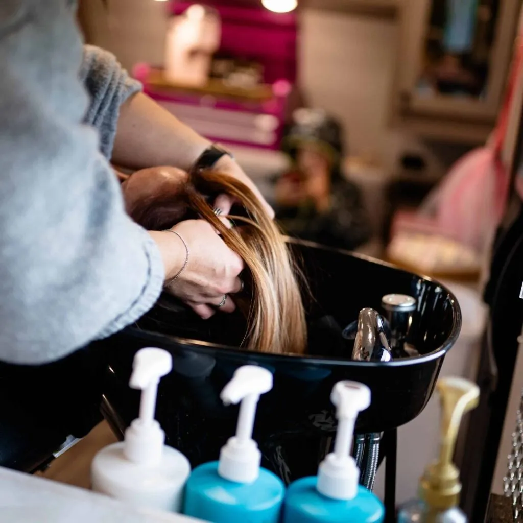 Client getting hair washed in mobile salon