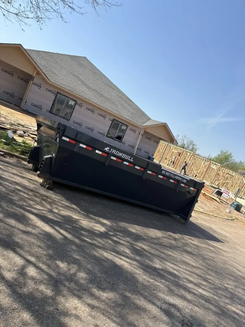 Ironbull roll-off dumpster parked at residential new construction site