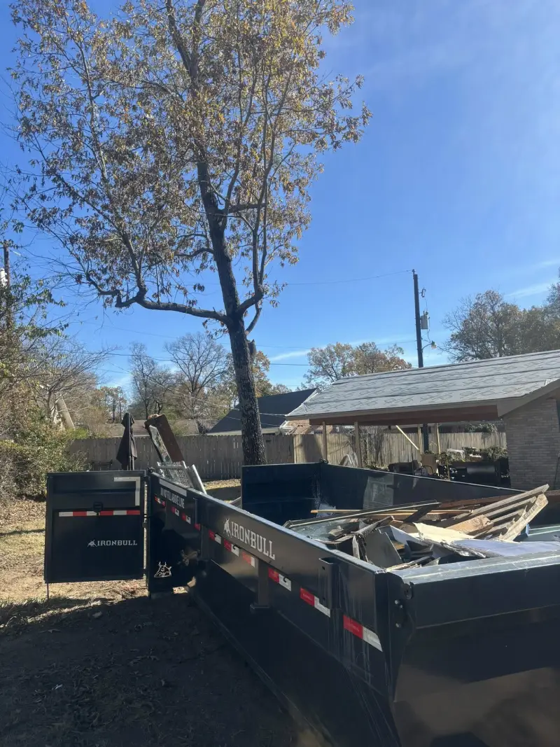 Dumpster loaded with debris and tree branches