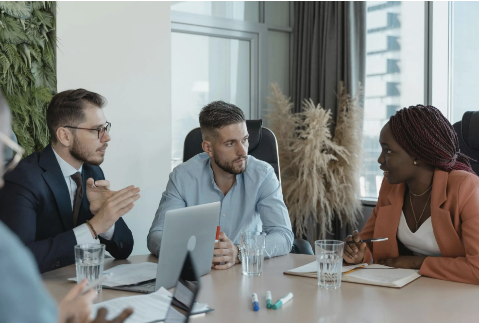 Diverse group of professionals in a leadership meeting, representing executive coaching and strategic guidance