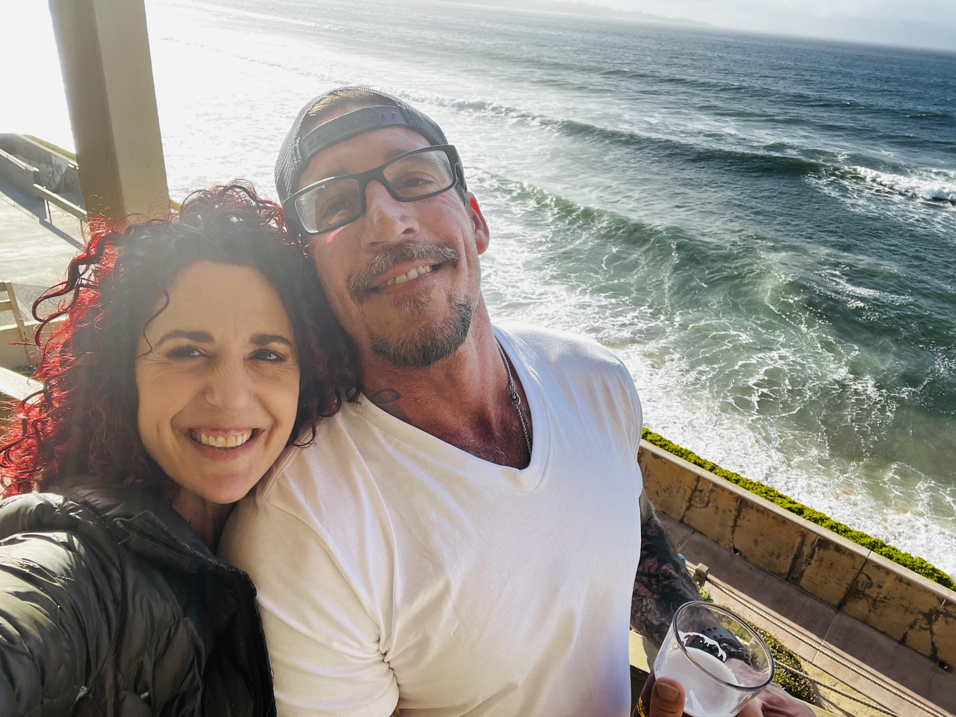 Alara and her partner by the ocean