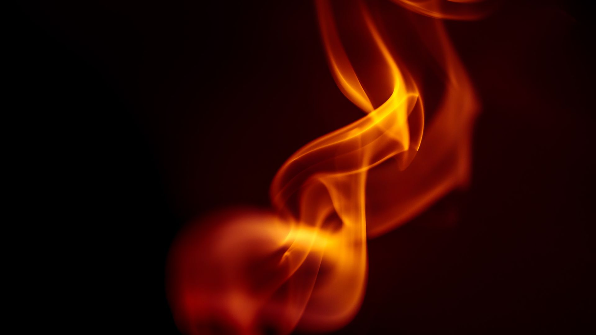Abstract glowing flame in darkness