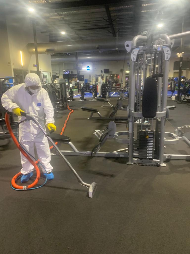 Professional mould remediation technician in commercial gym