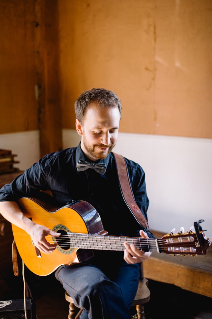Thomas playing guitar indoors