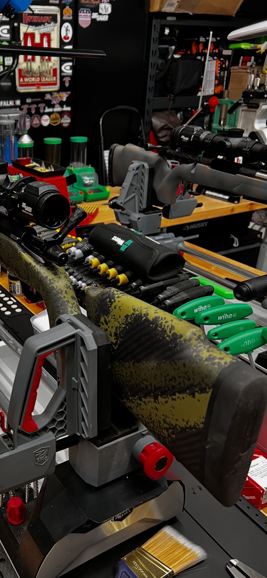 Rifle stock in workshop vise with specialized gunsmithing tools at Precise Arms