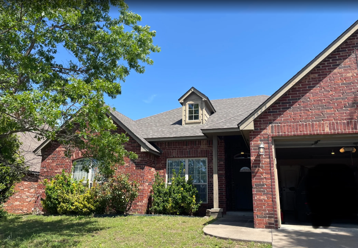 New architectural shingle roof replacement on a brick home in Tulsa, OK