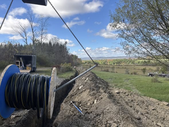 Laying cable and pipe in a fresh trench