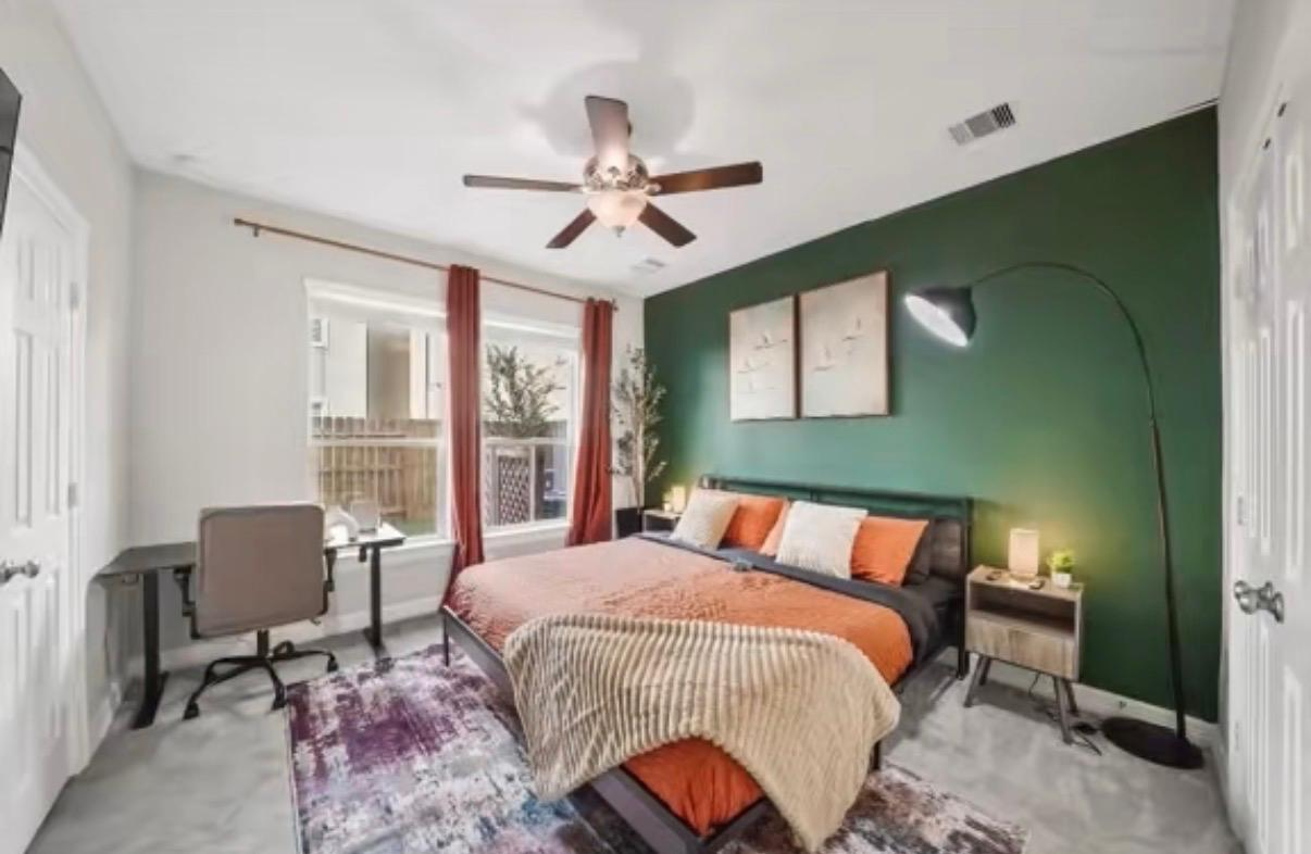 Tidy bedroom with green accent wall cleaning service