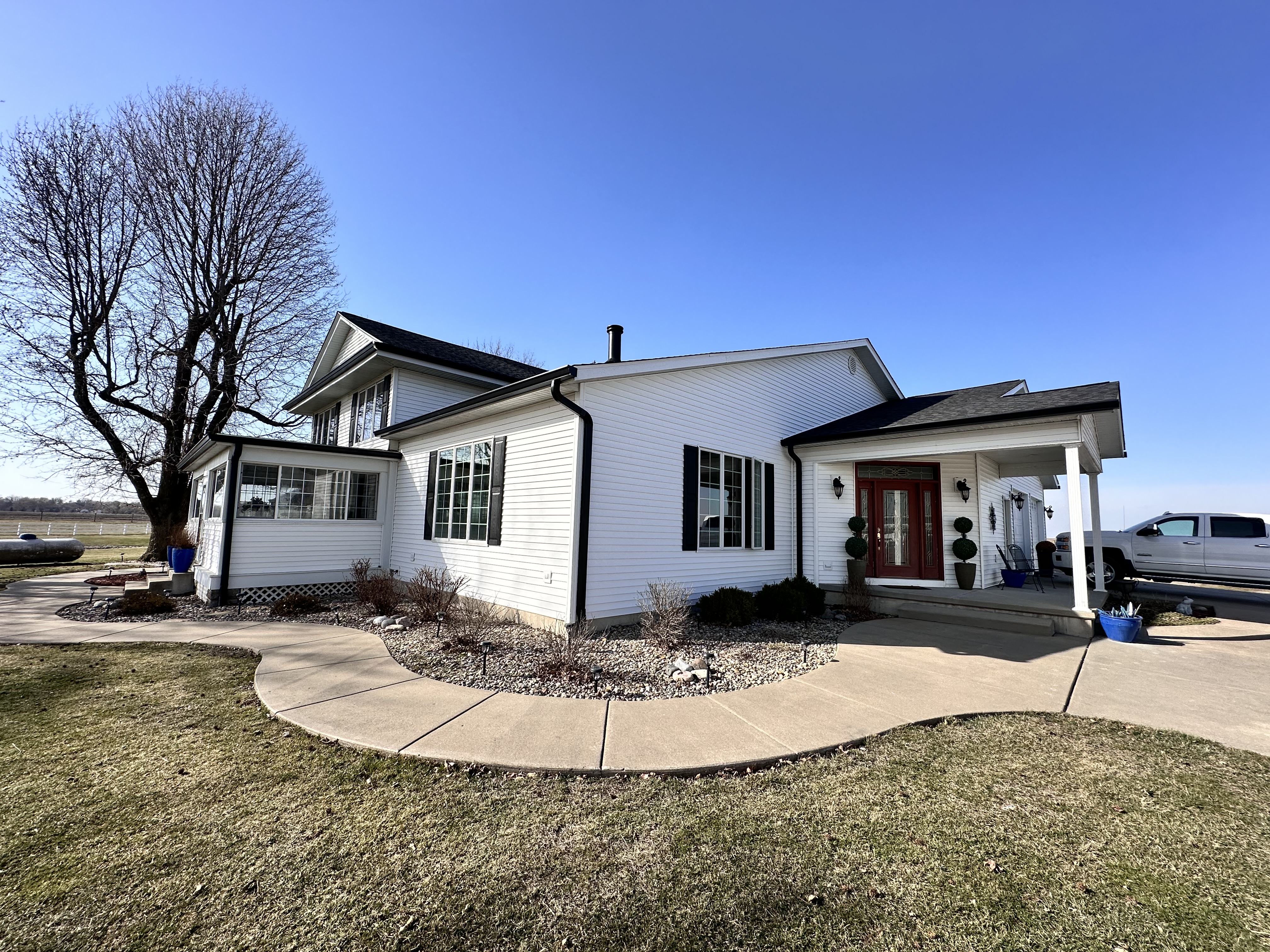 White home upgrade — Seamless gutters on a white home with black trim. in Central IL