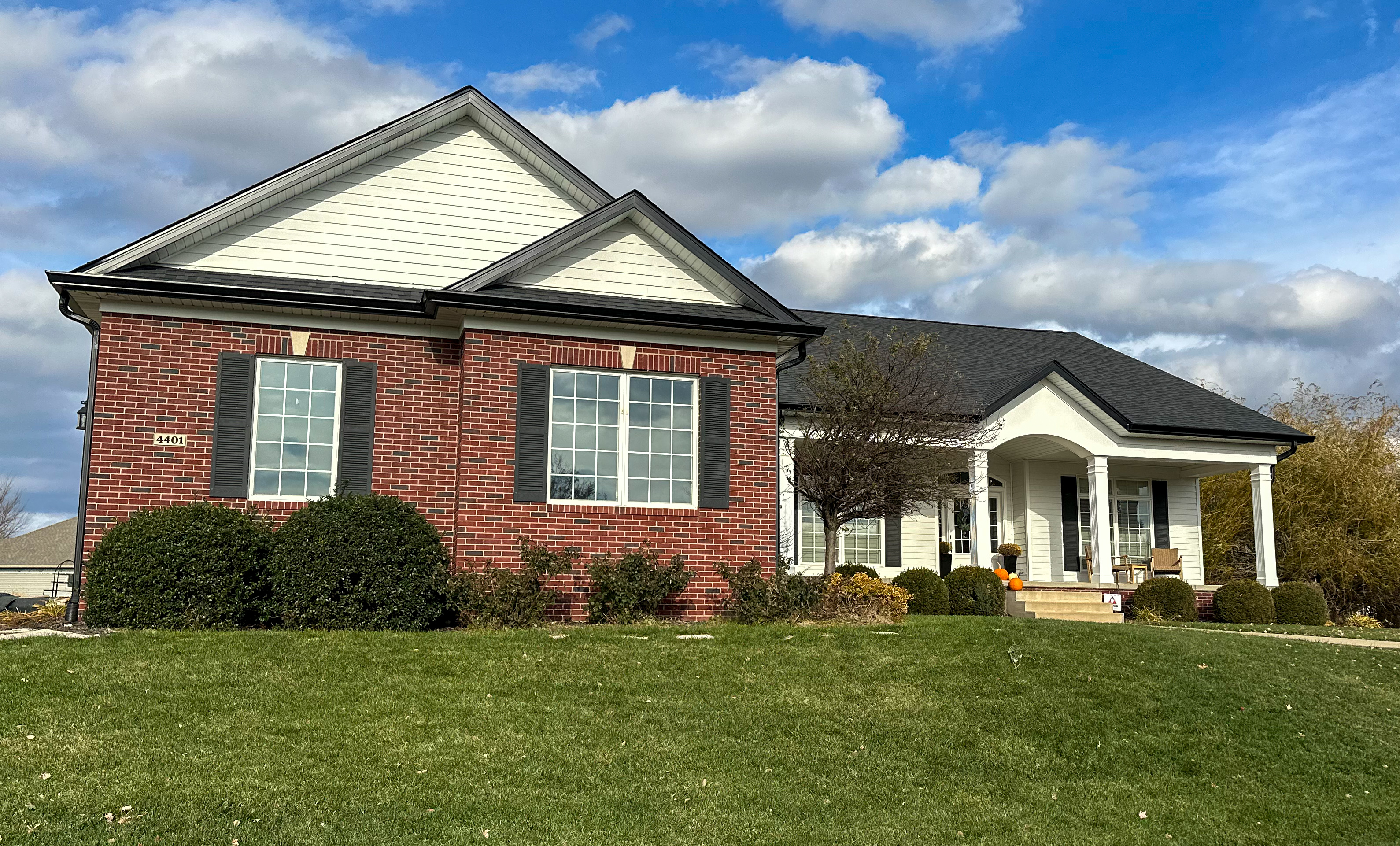 Brick home upgrade — White seamless gutters matching the trim. in Central IL