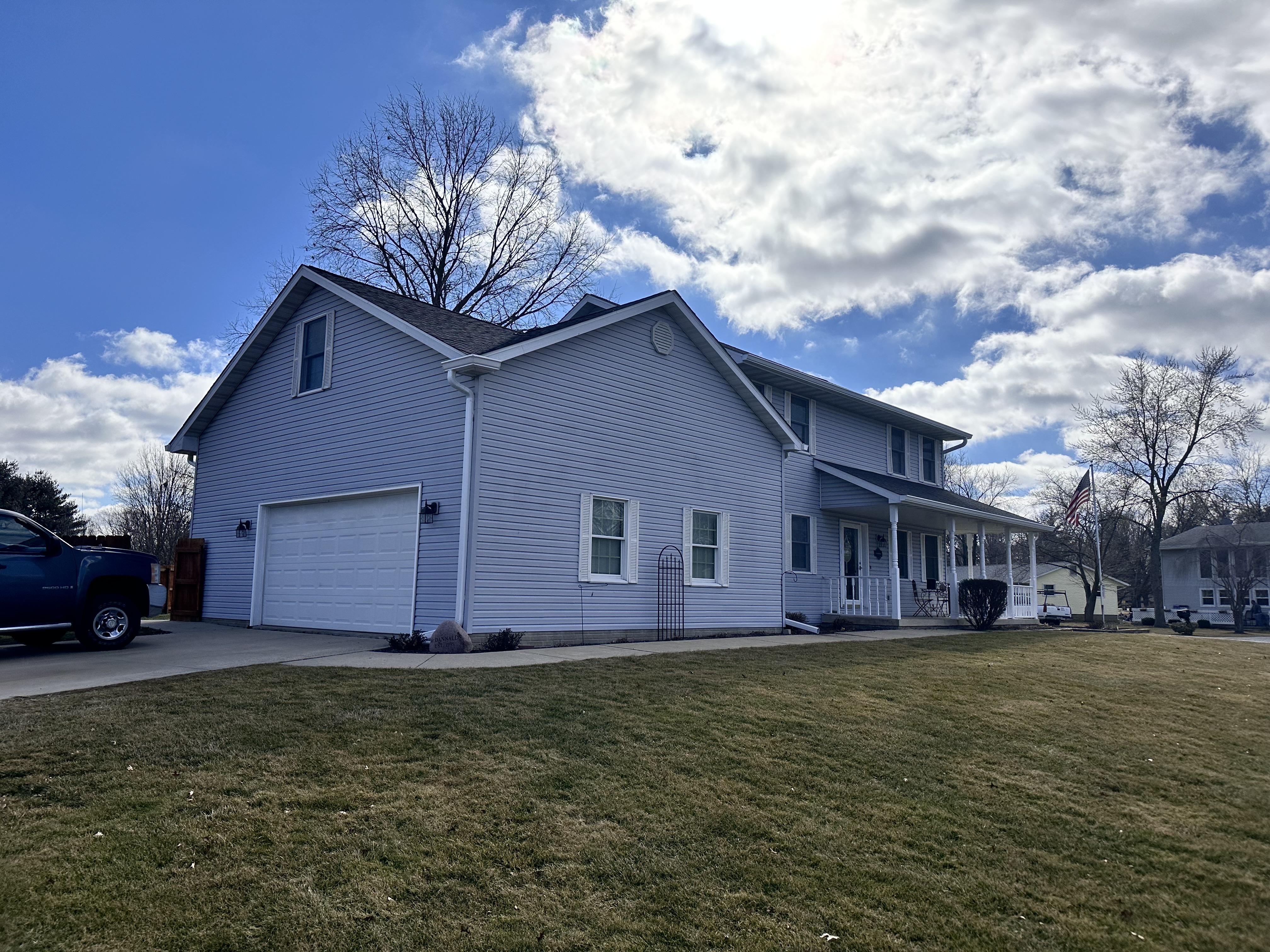 Seamless install — Two-story home, light blue siding with white gutters. in Lincoln, IL