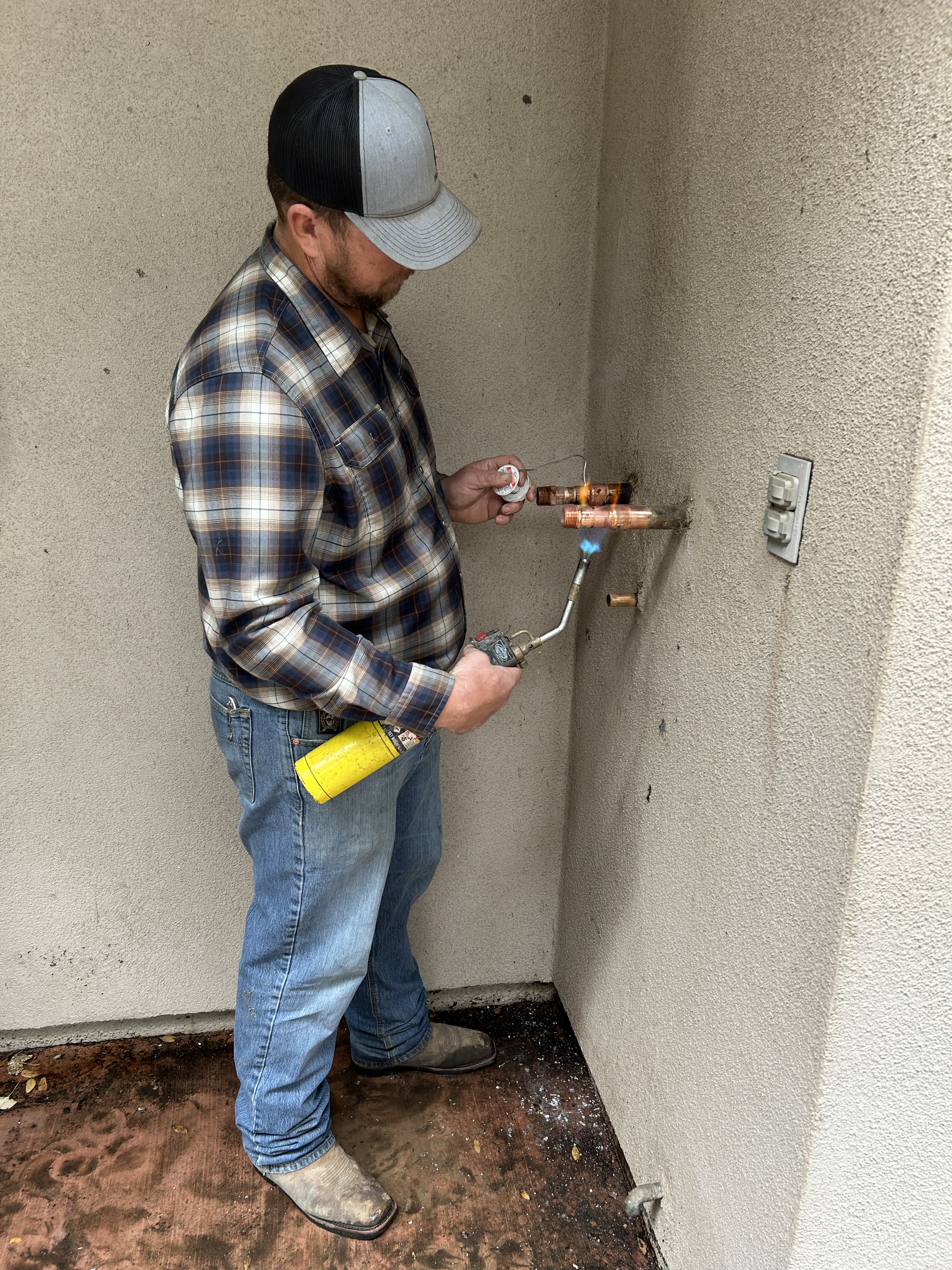 Plumber working on copper pipes