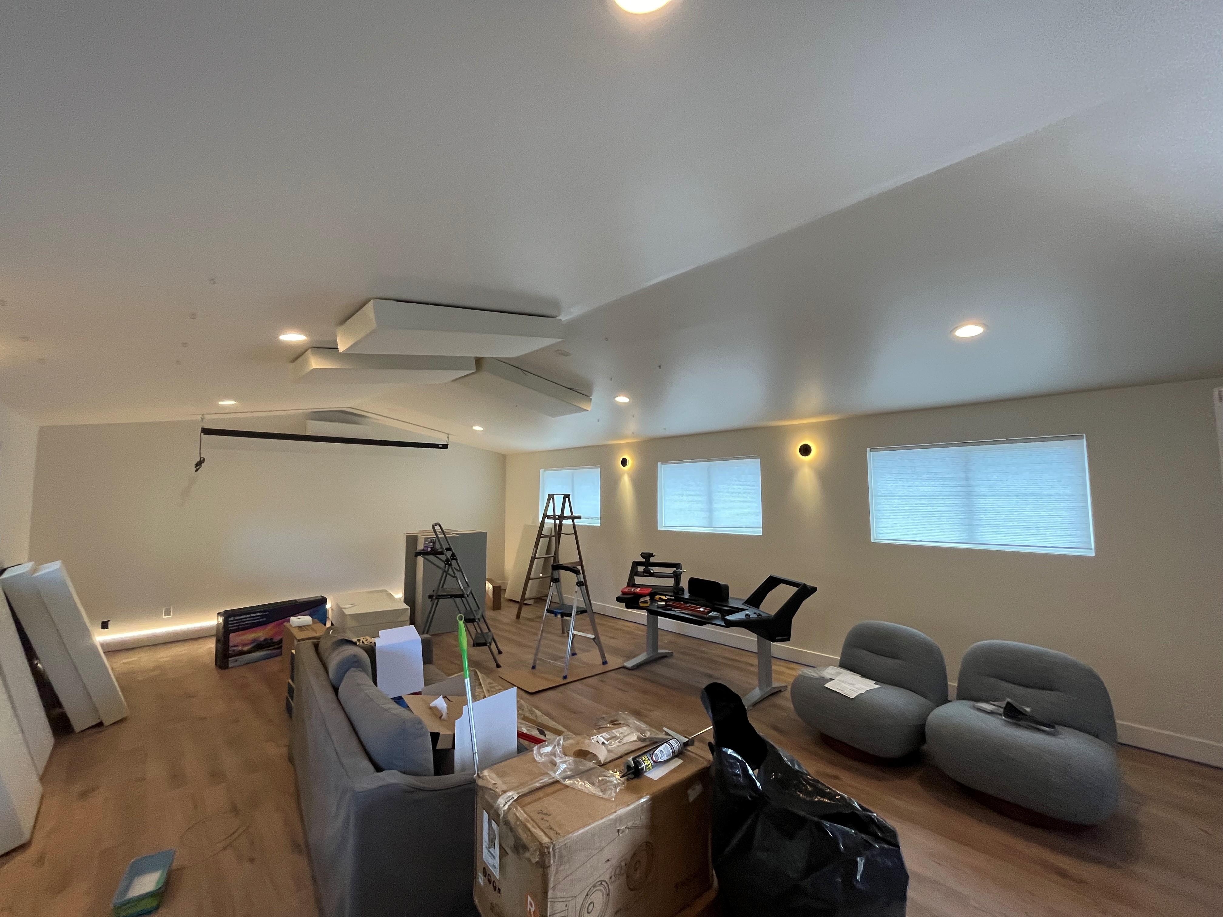 Room under construction with new recessed lighting and wall sconces