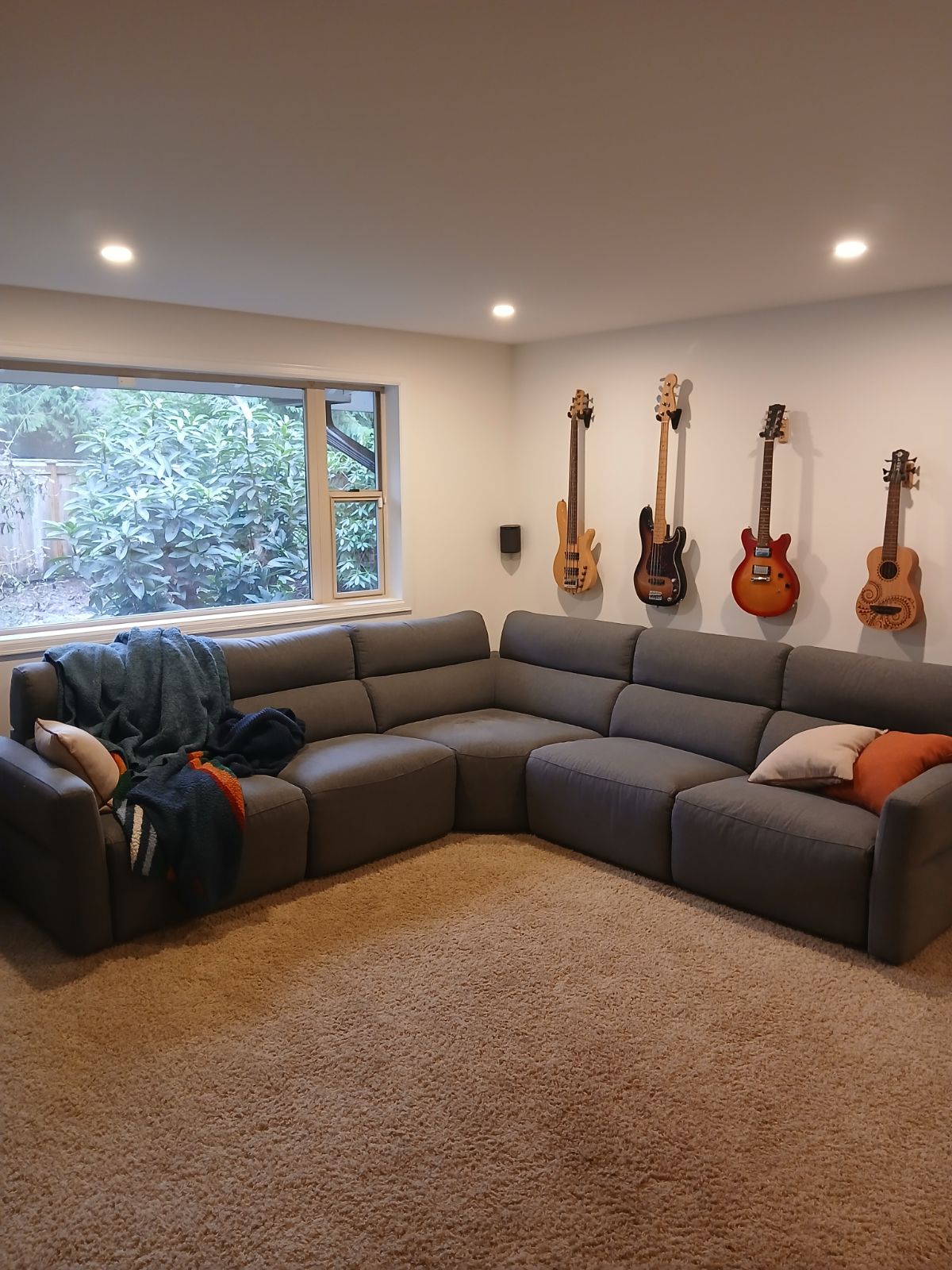 Cozy basement living room with warm recessed lighting