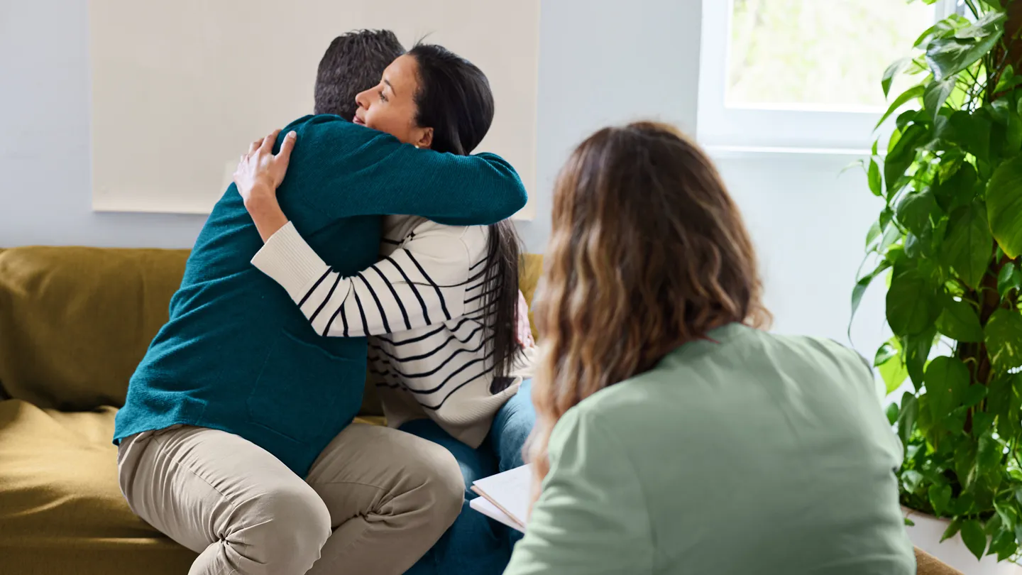 Couple hugging during consultation