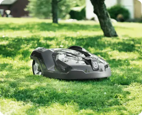 Robotic mower on lush green lawn