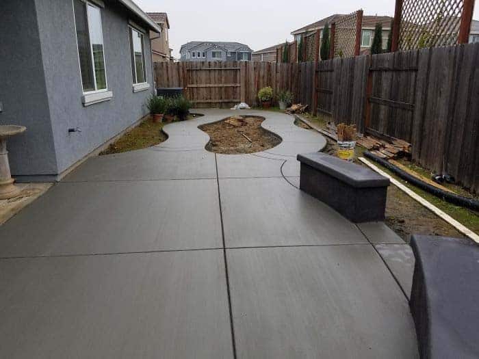 Artificial turf installation surrounding backyard pool perimeter in Moorpark estate