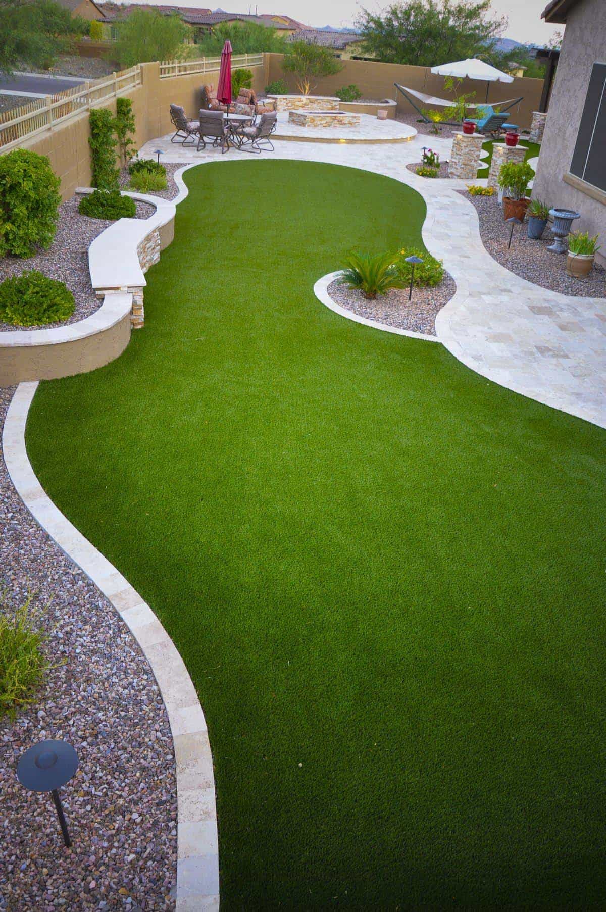Custom fire pit feature with smooth concrete cap and flagstone surround in Simi Valley