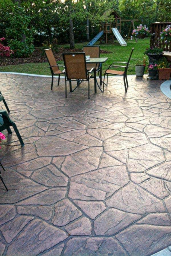 Drought-tolerant synthetic lawn installation with landscape boulder accents in Santa Paula