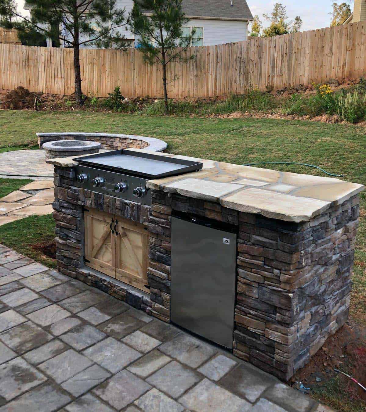 Gourmet outdoor BBQ island with side burners and custom stone finish in Santa Paula development