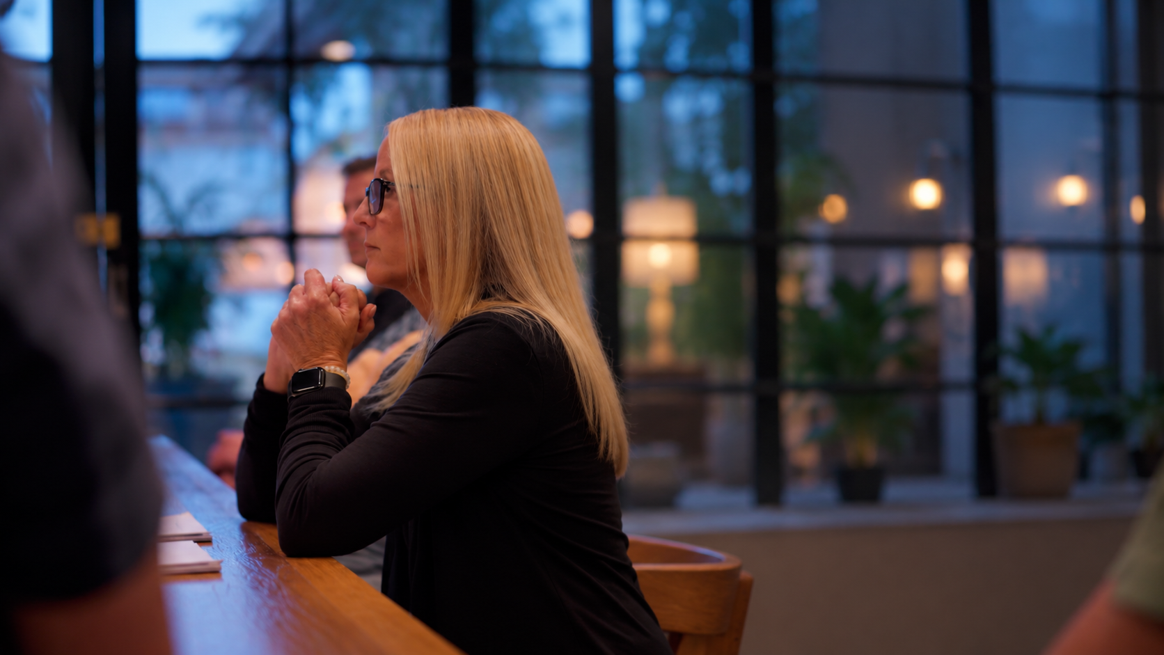 Amanda Dake seated at table in conversation